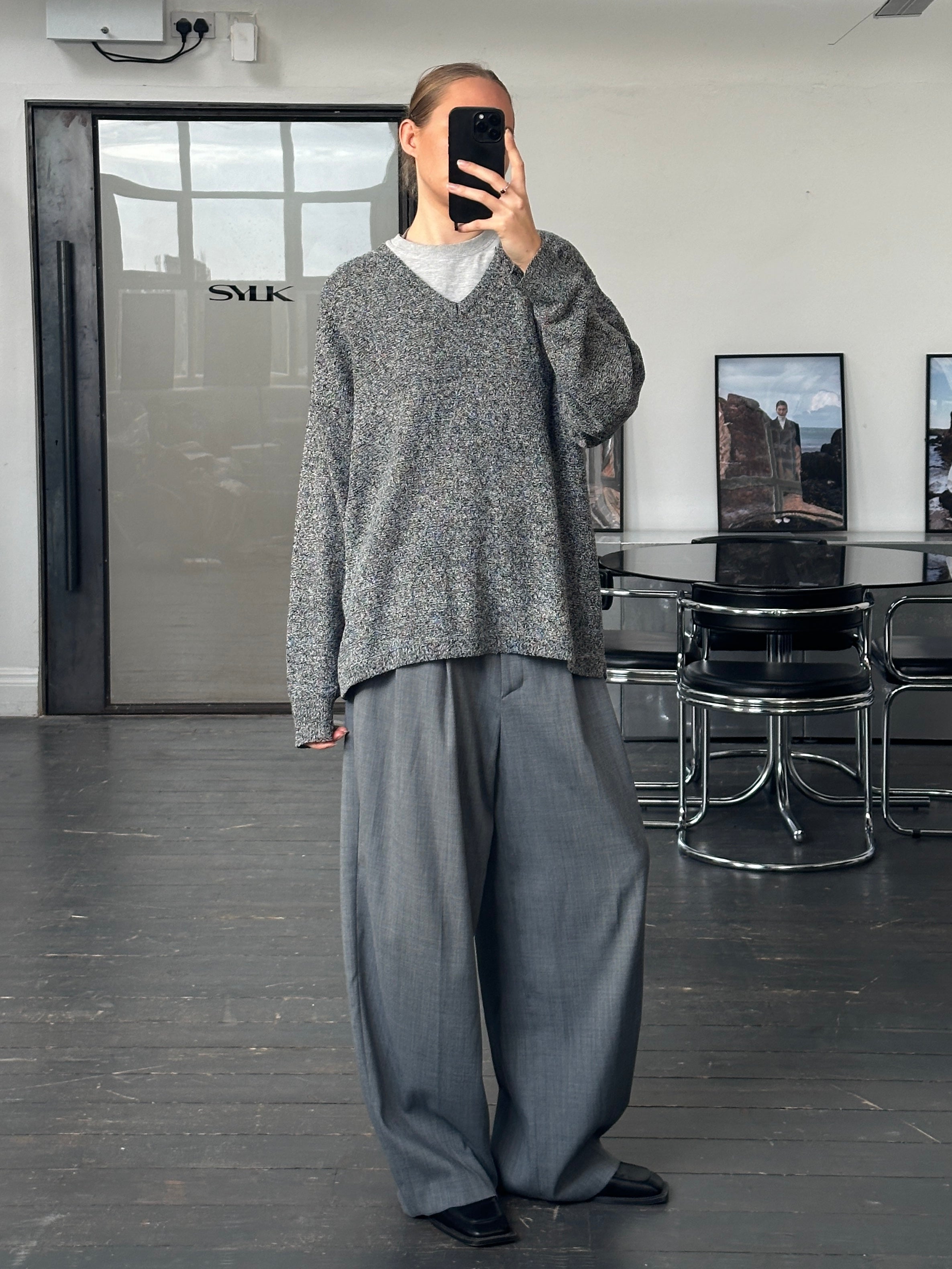 Versace Jeans Couture 1990s wool V-neck jumper in XL, shown in black with classic knit texture and brand logo details.