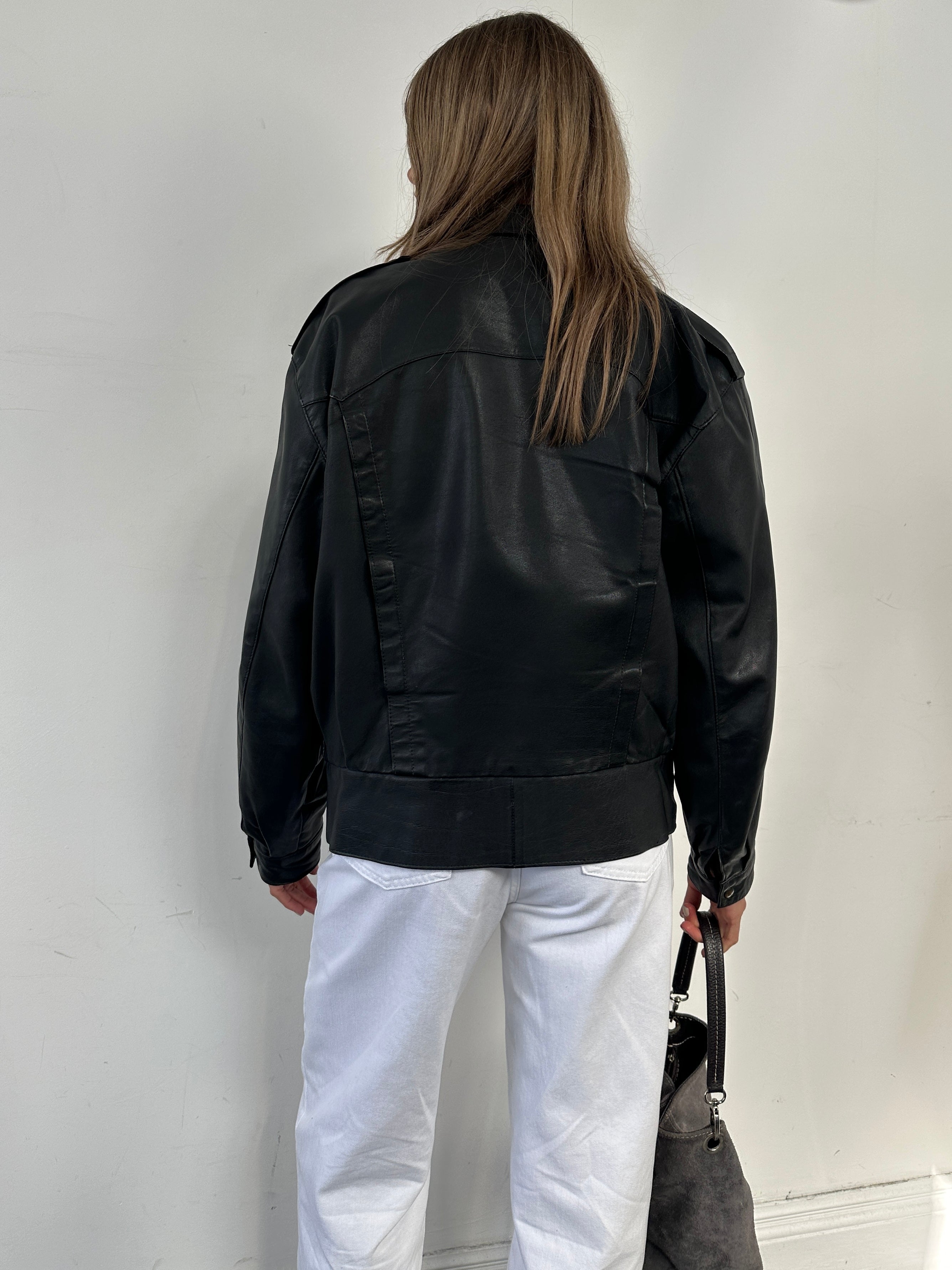 Vintage Leather Bomber Jacket in size small, featuring classic design, ribbed cuffs, and a worn-in leather finish.