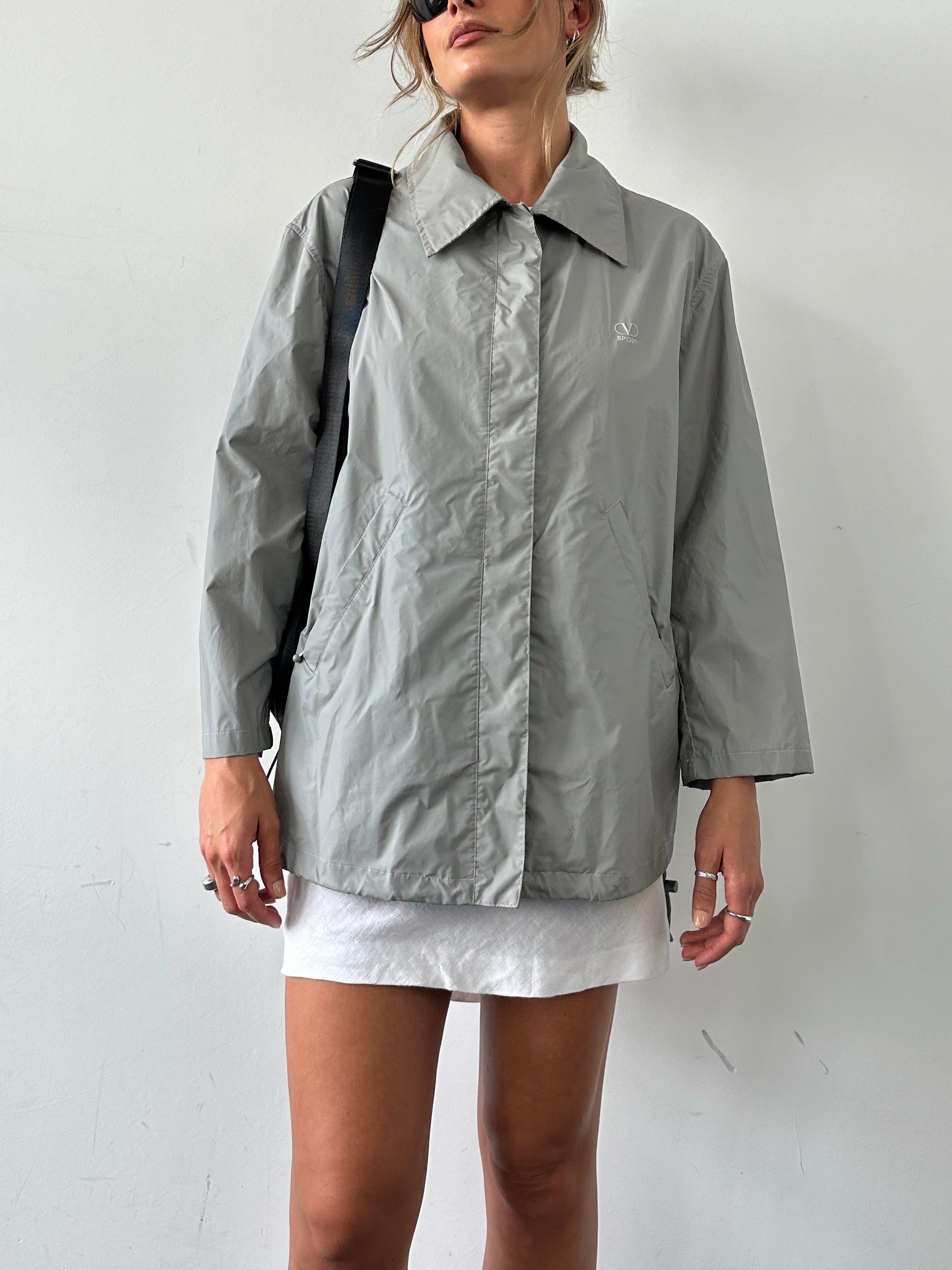 Valentino Sport raincoat jacket in size L, lightweight waterproof jacket with Valentino branding, blue color, and sporty design.