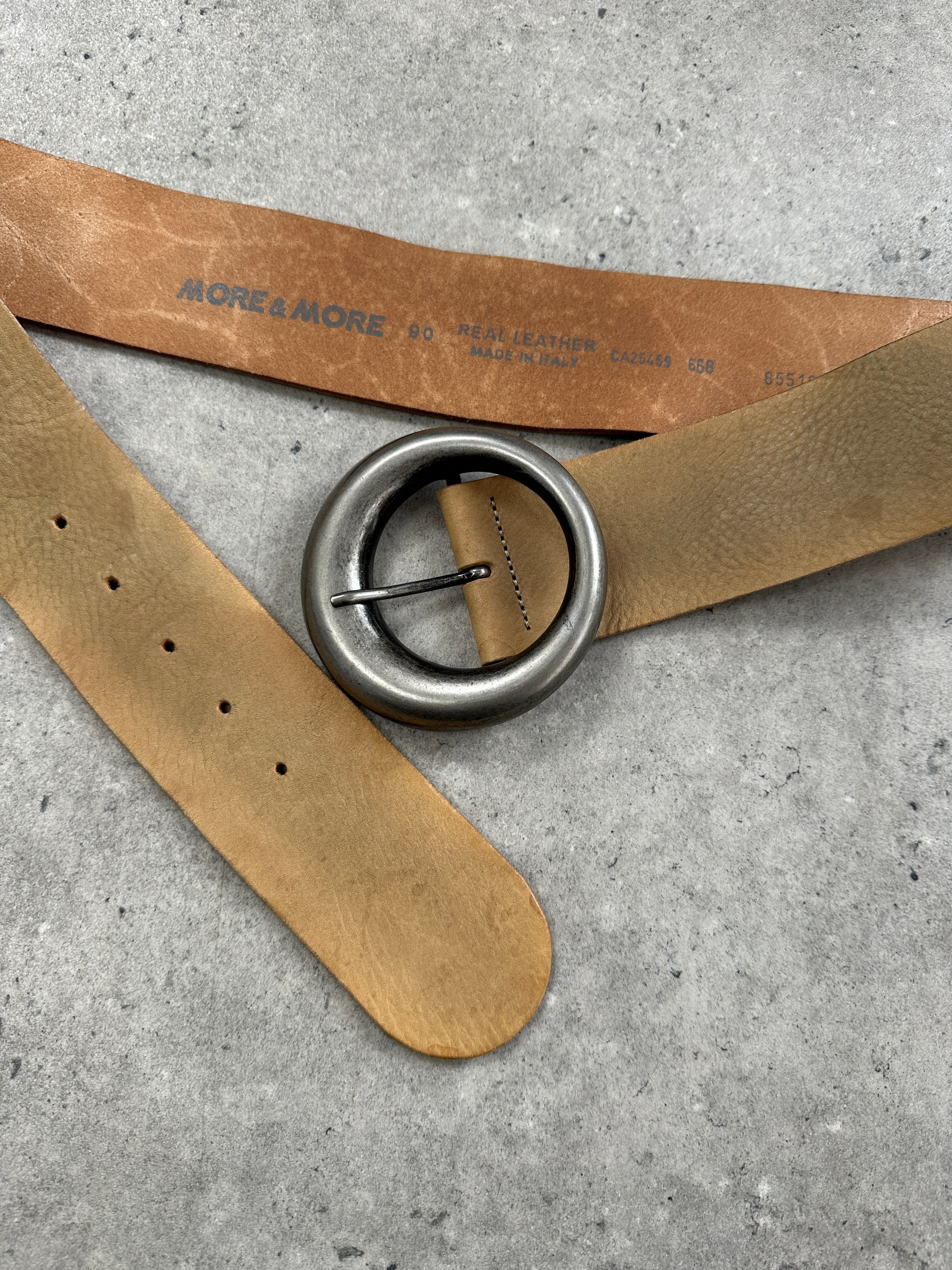 Vintage 1990s circular buckle leather belt in natural brown with adjustable W32-36 size, showcasing retro style and craftsmanship.