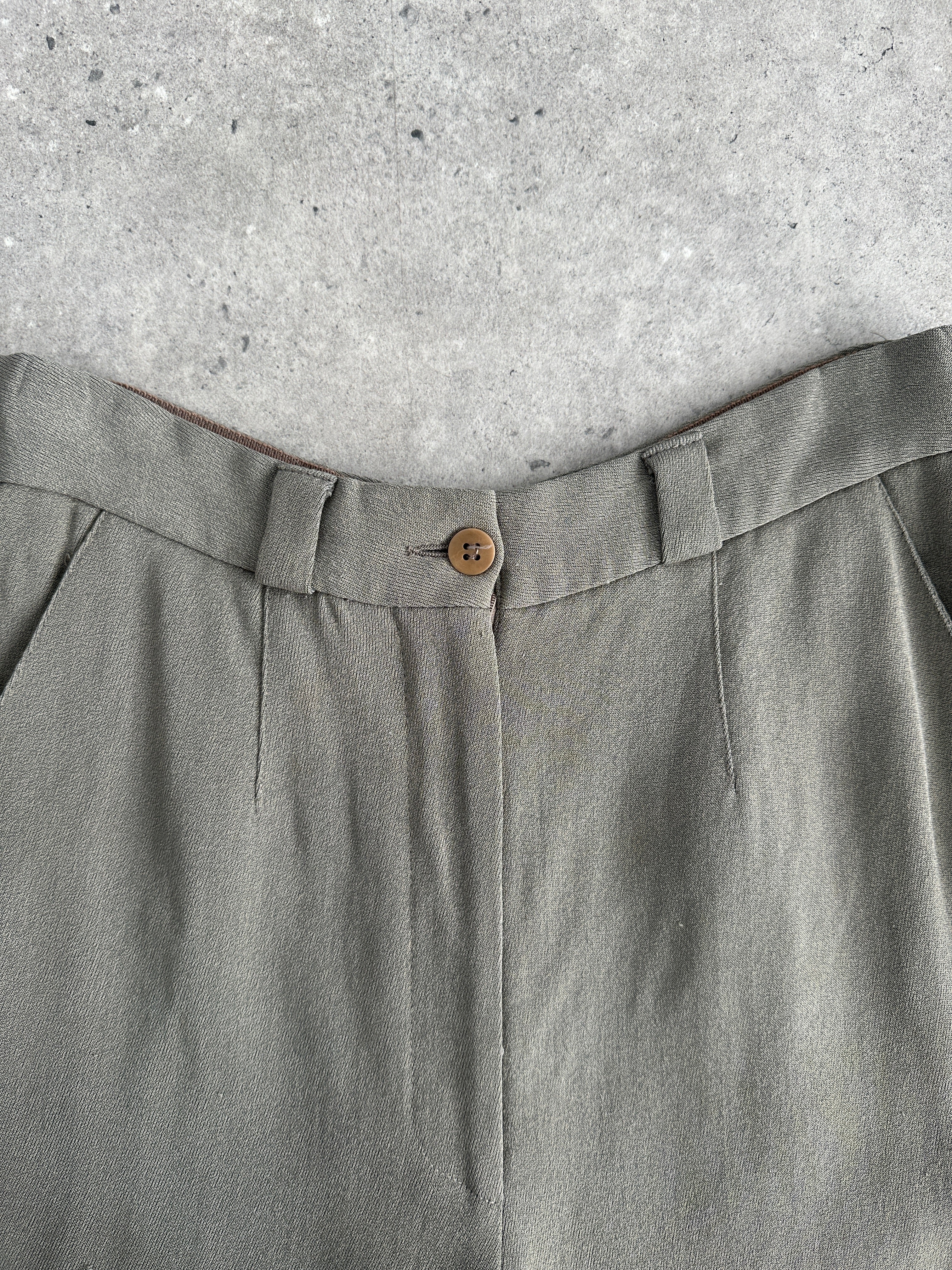 Giorgio Armani high-waisted tapered leg trousers in black, tailored fit, with belt loops and front pockets, styled on a model.