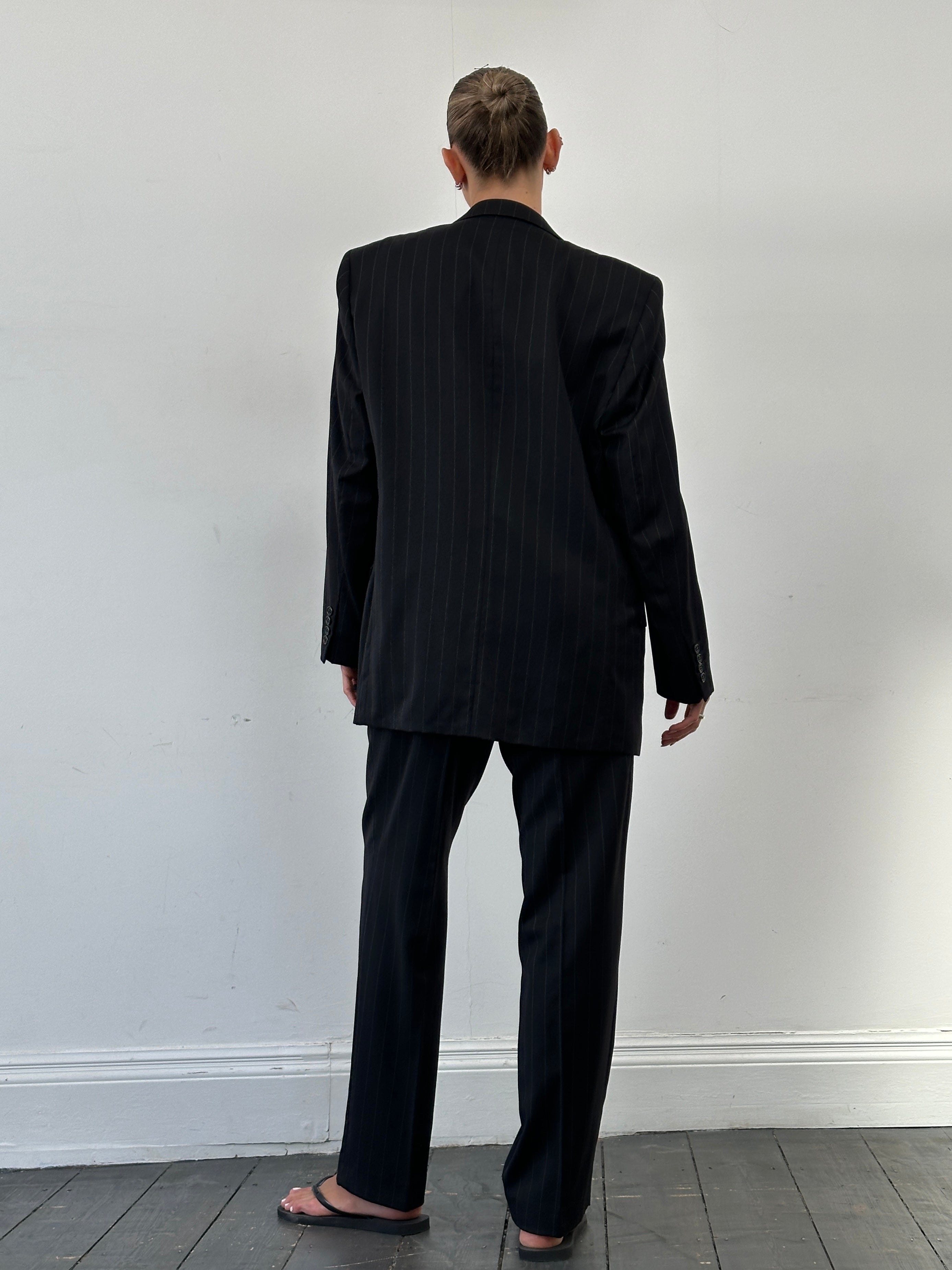 Vintage brand vintage pure wool pinstripe jumpsuit, single-breasted suit in size 40R/W34, shown on a hanger.