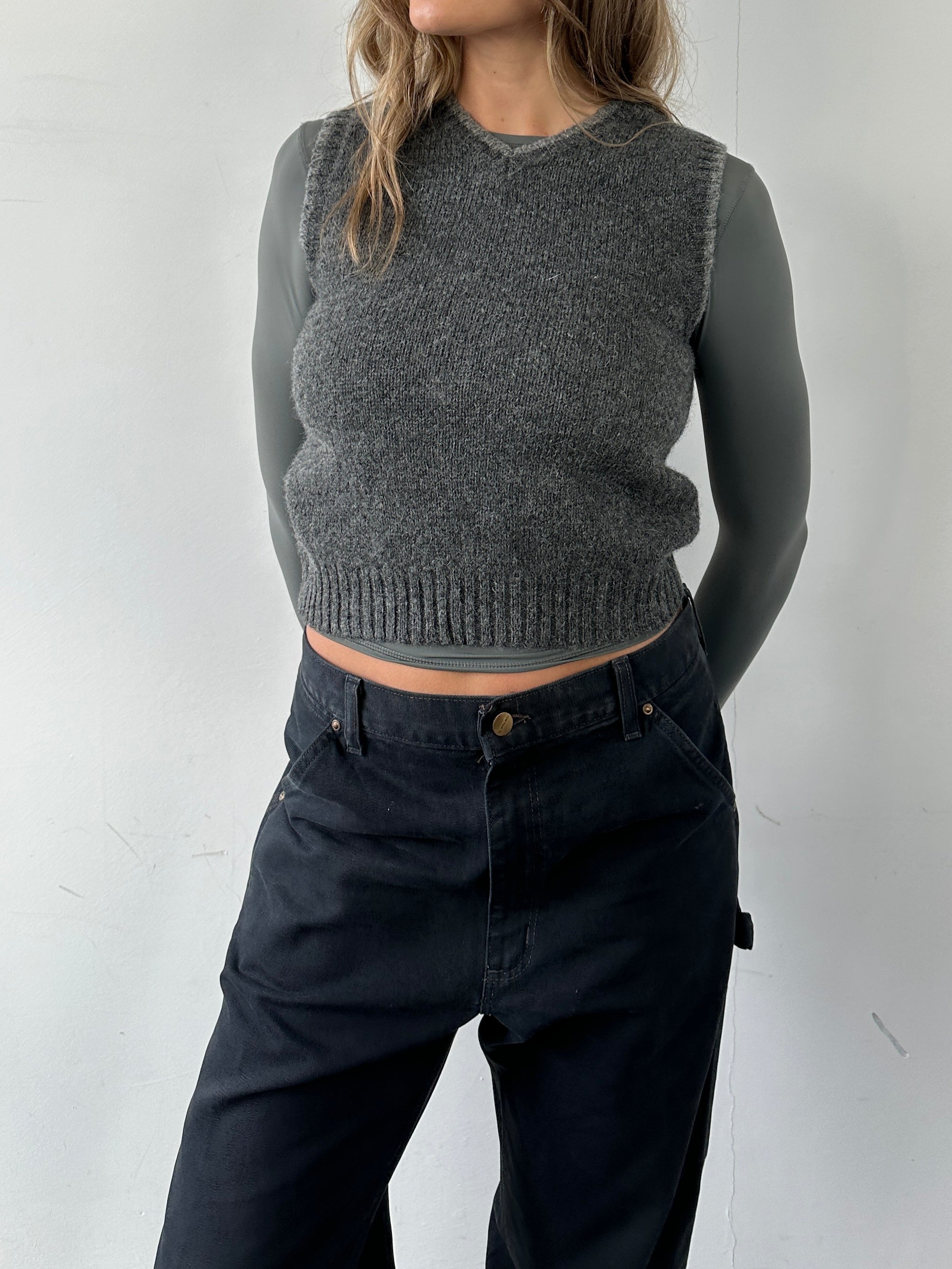 Vintage pure Shetland wool sleeveless vest jumper, showing a cozy, natural textured wool fabric in a classic design.