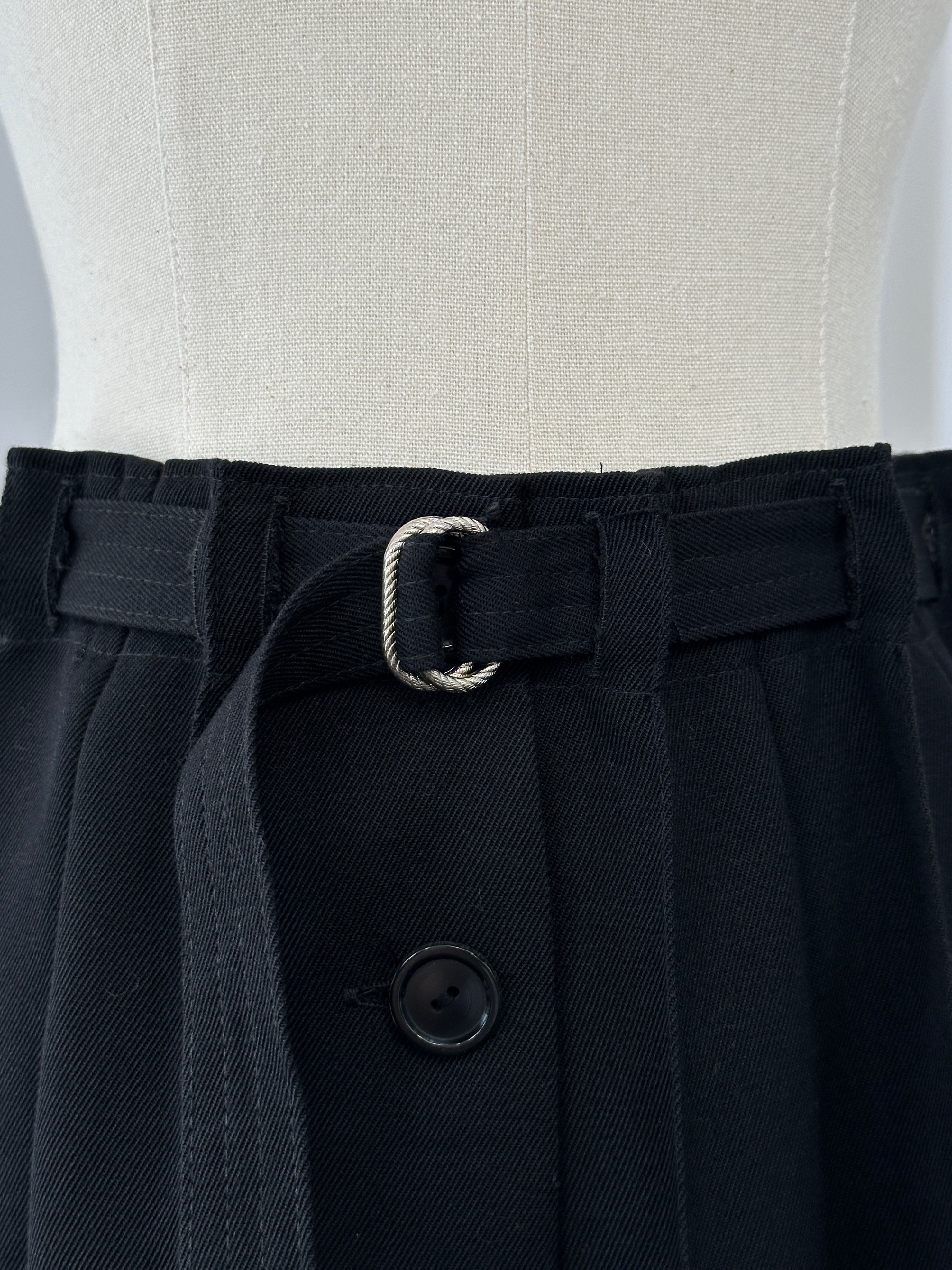 Vintage 1990s wool pleated midi skirt in mustard yellow with side pockets, size W26, showcasing classic retro style.