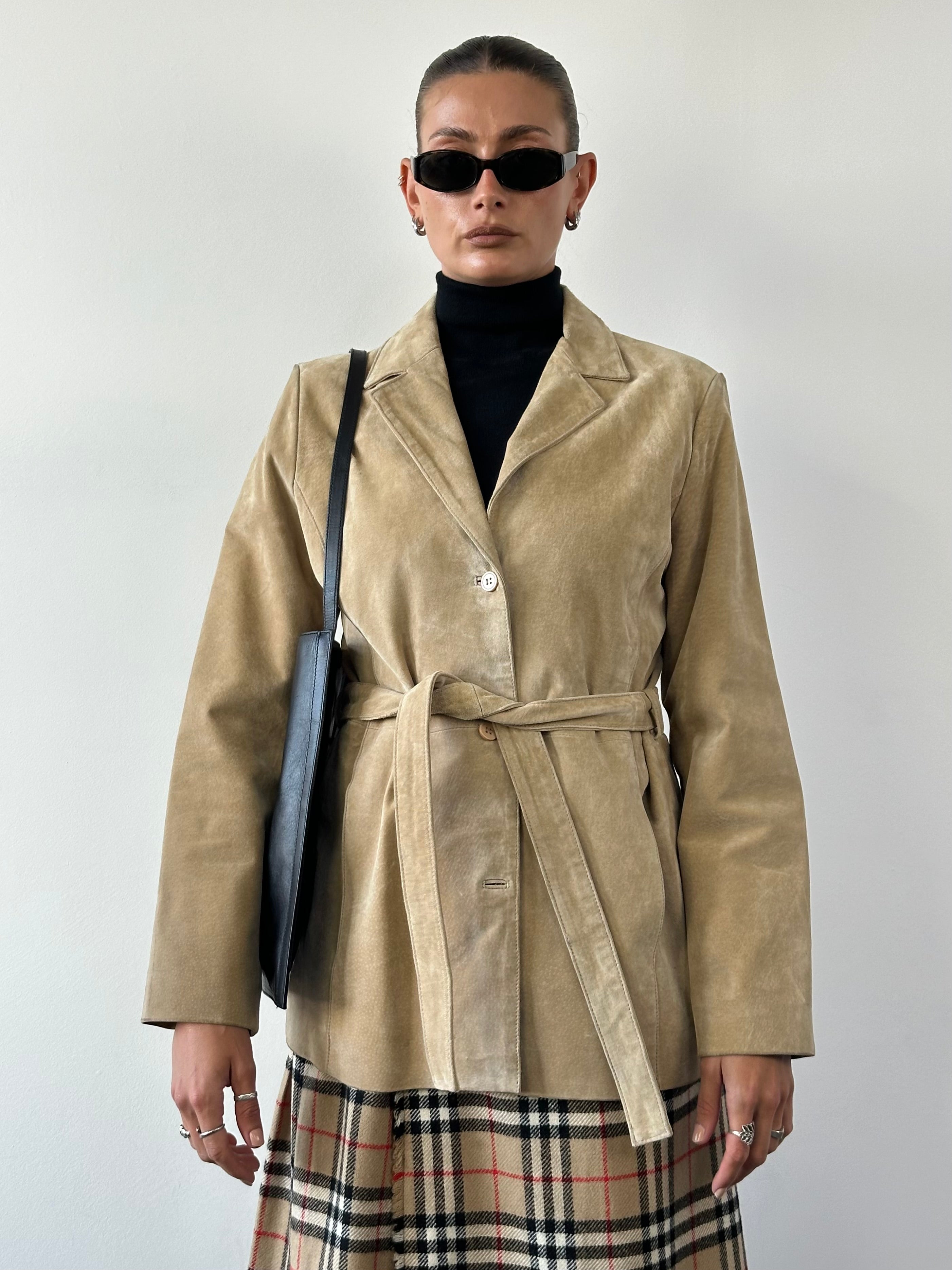 Vintage suede belted jacket with classic design, featuring a tailored fit and stylish details, perfect for casual or semi-formal wear.
