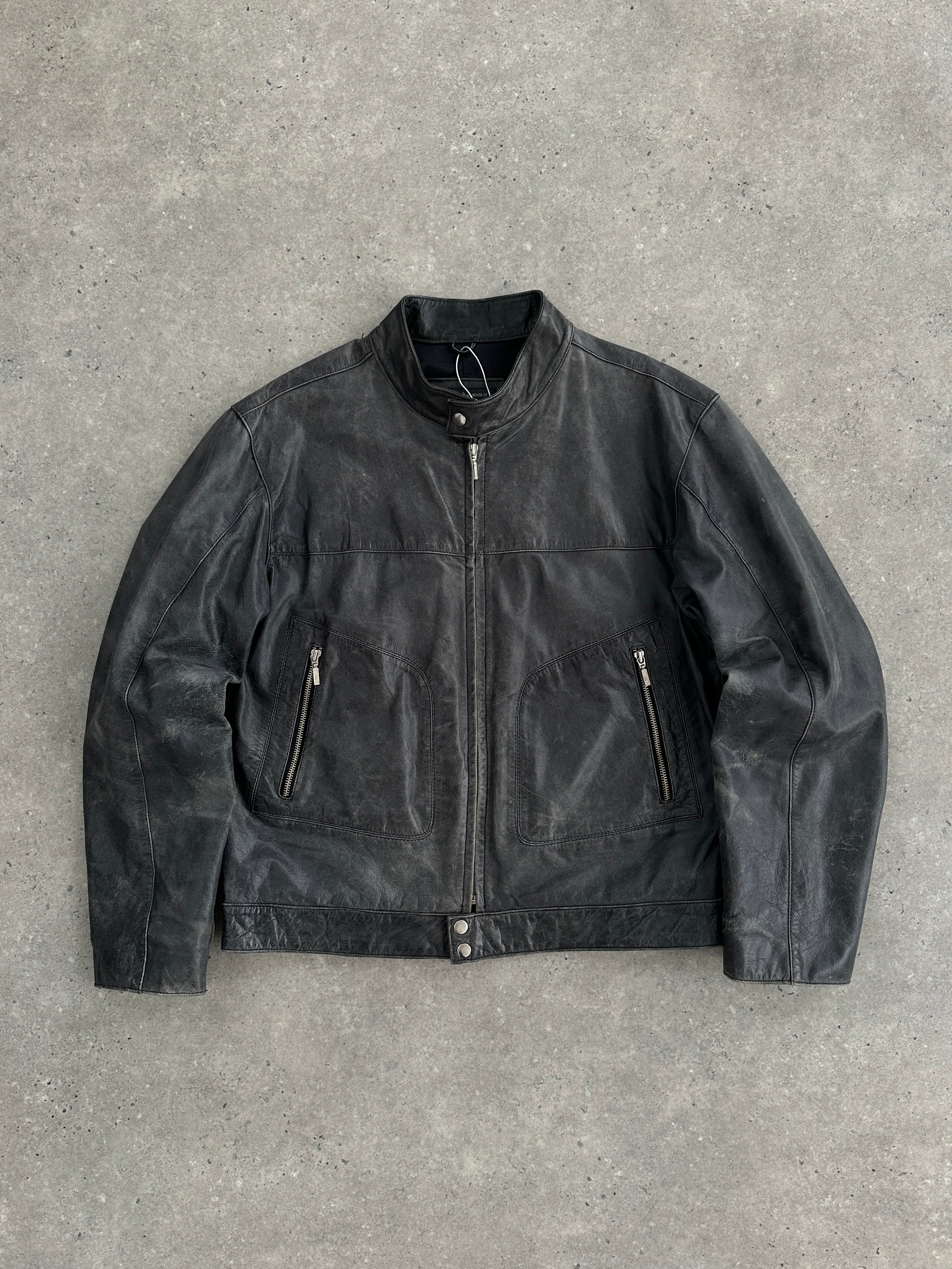 Vintage distressed leather motorcycle jacket in size L/XL, featuring rugged design and classic moto style with visible worn details.