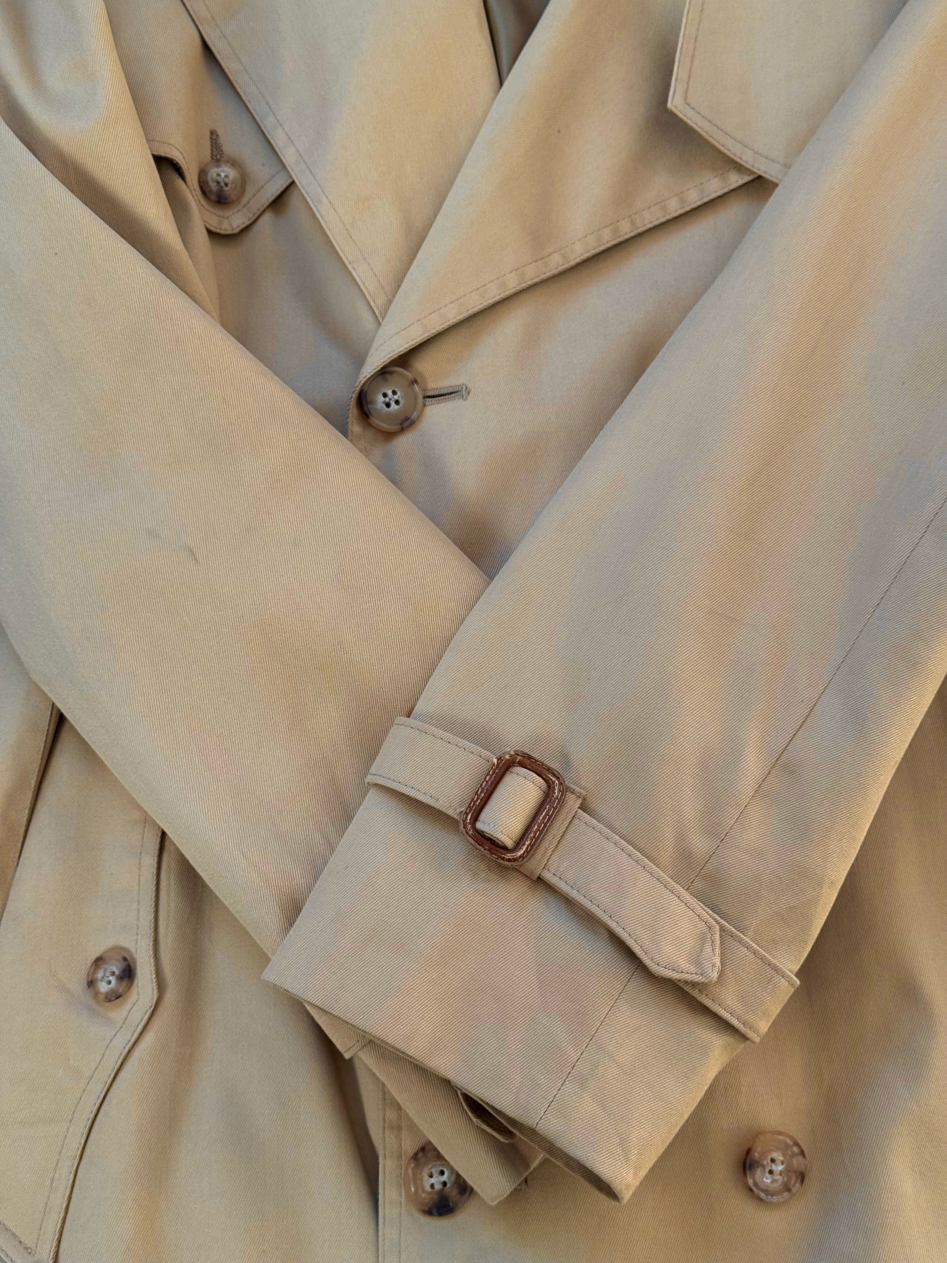 Christian Dior Paris 1980s cotton double-breasted trench coat in size L, shown hanging with classic belt and tailored fit.