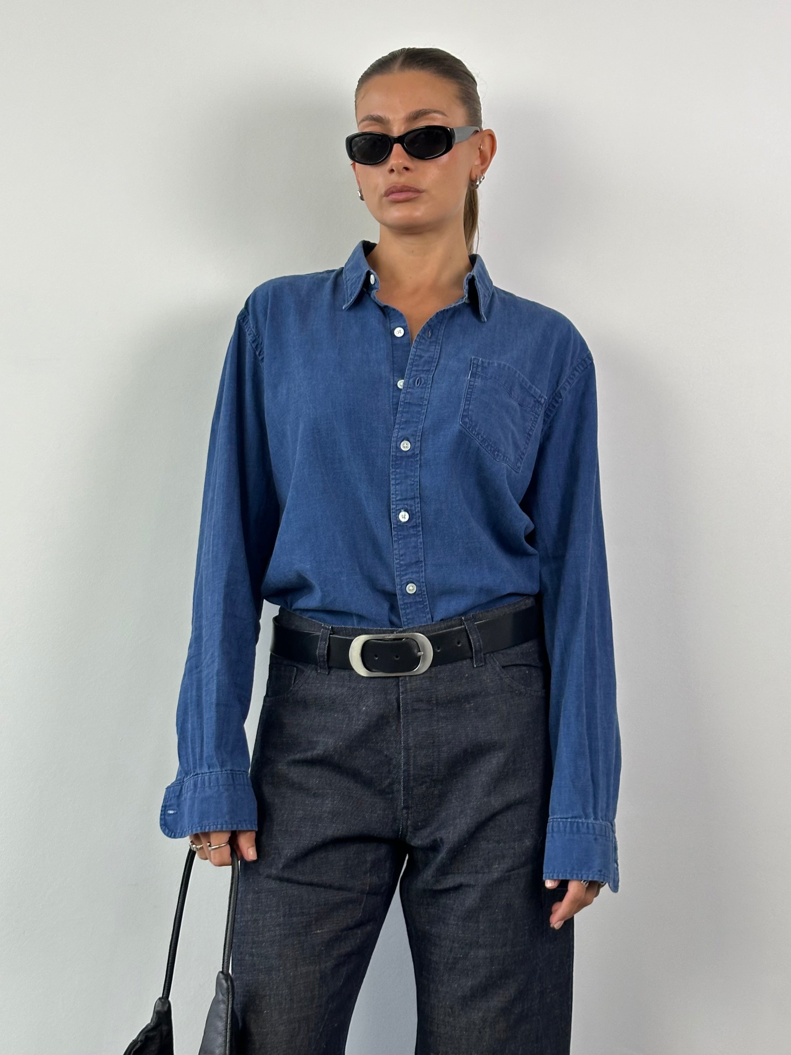 Levi’s Pure Cotton Denim Shirt in XL, featuring classic button-up design and light blue denim fabric, displayed on a hanger.