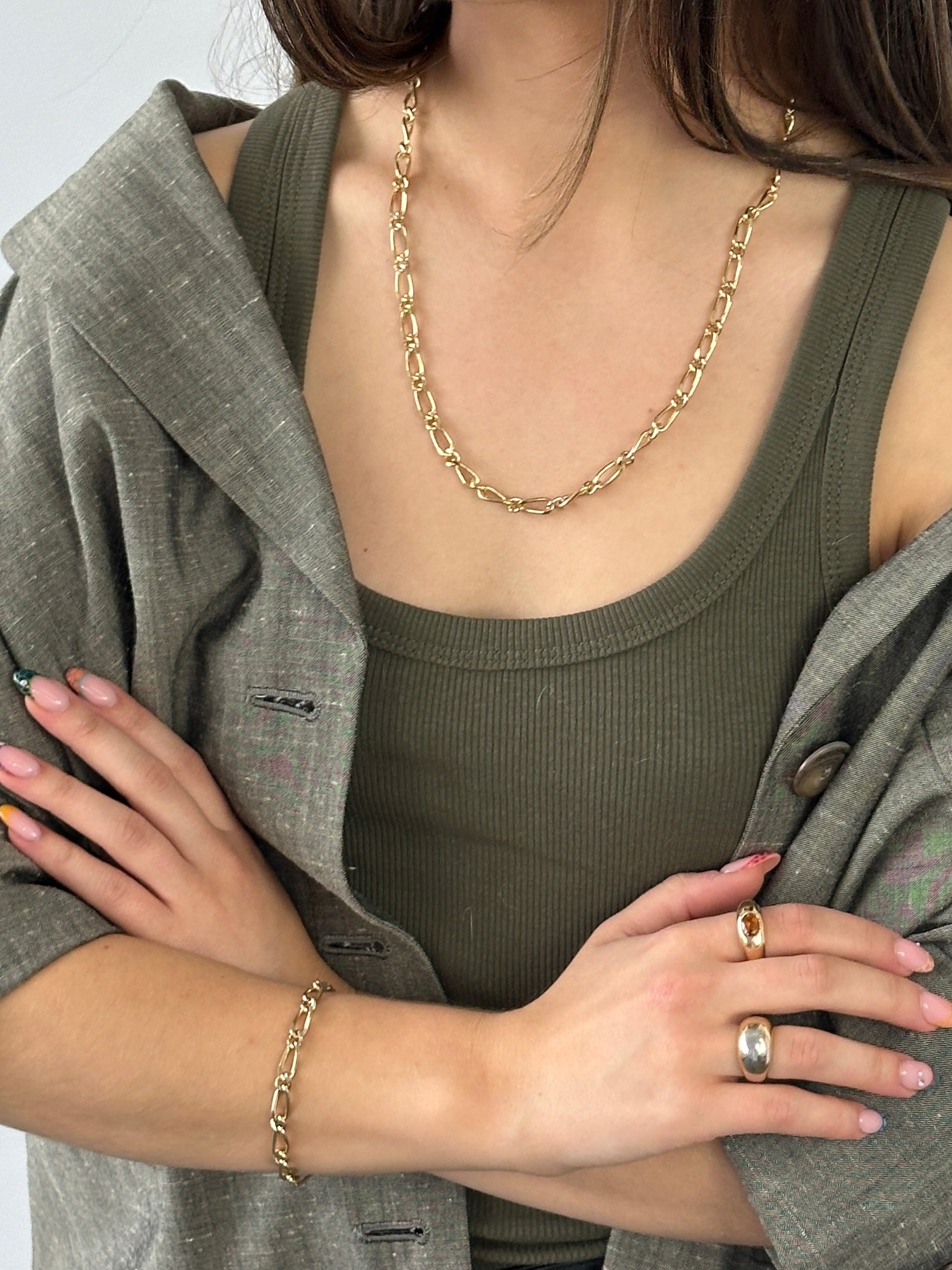 Pierre Cardin gold-plated necklace and bracelet chain set with shiny links and elegant design, displayed on a white background.