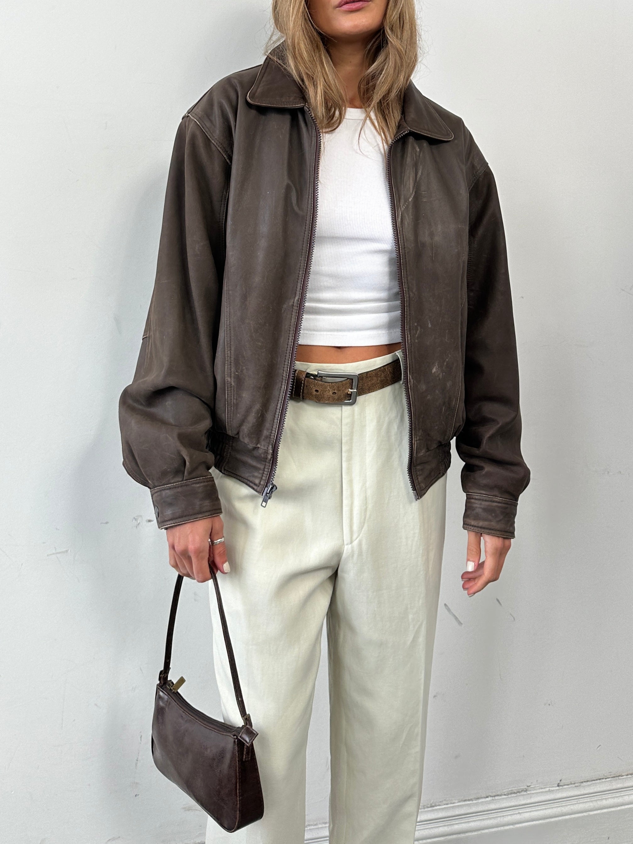 Vintage distressed leather bomber jacket for men, featuring a classic fit and rugged style.