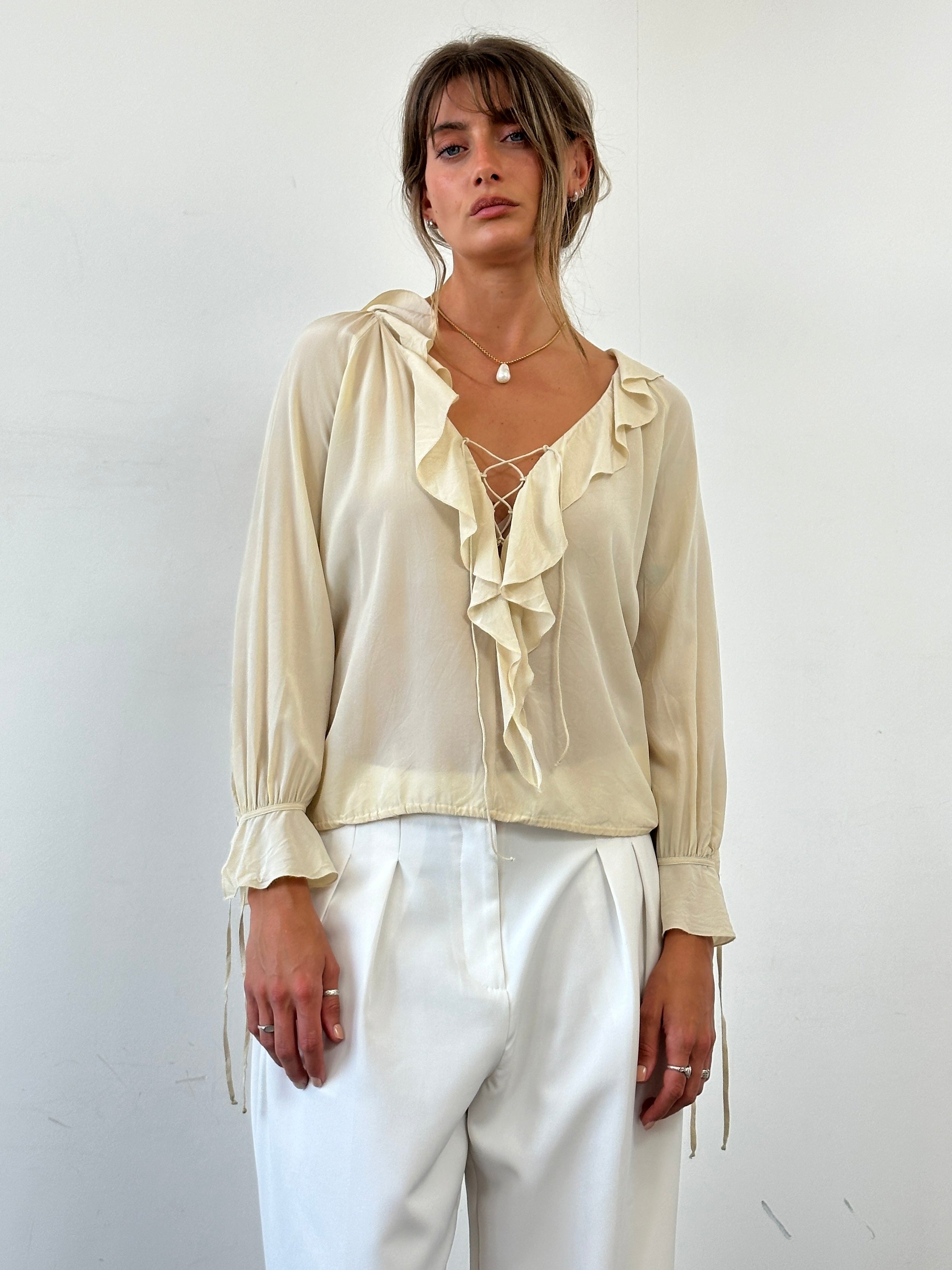 Max Mara silk ruffle tie-front blouse in S/M displayed, featuring a stylish collar, ruffled details, and elegant fabric.