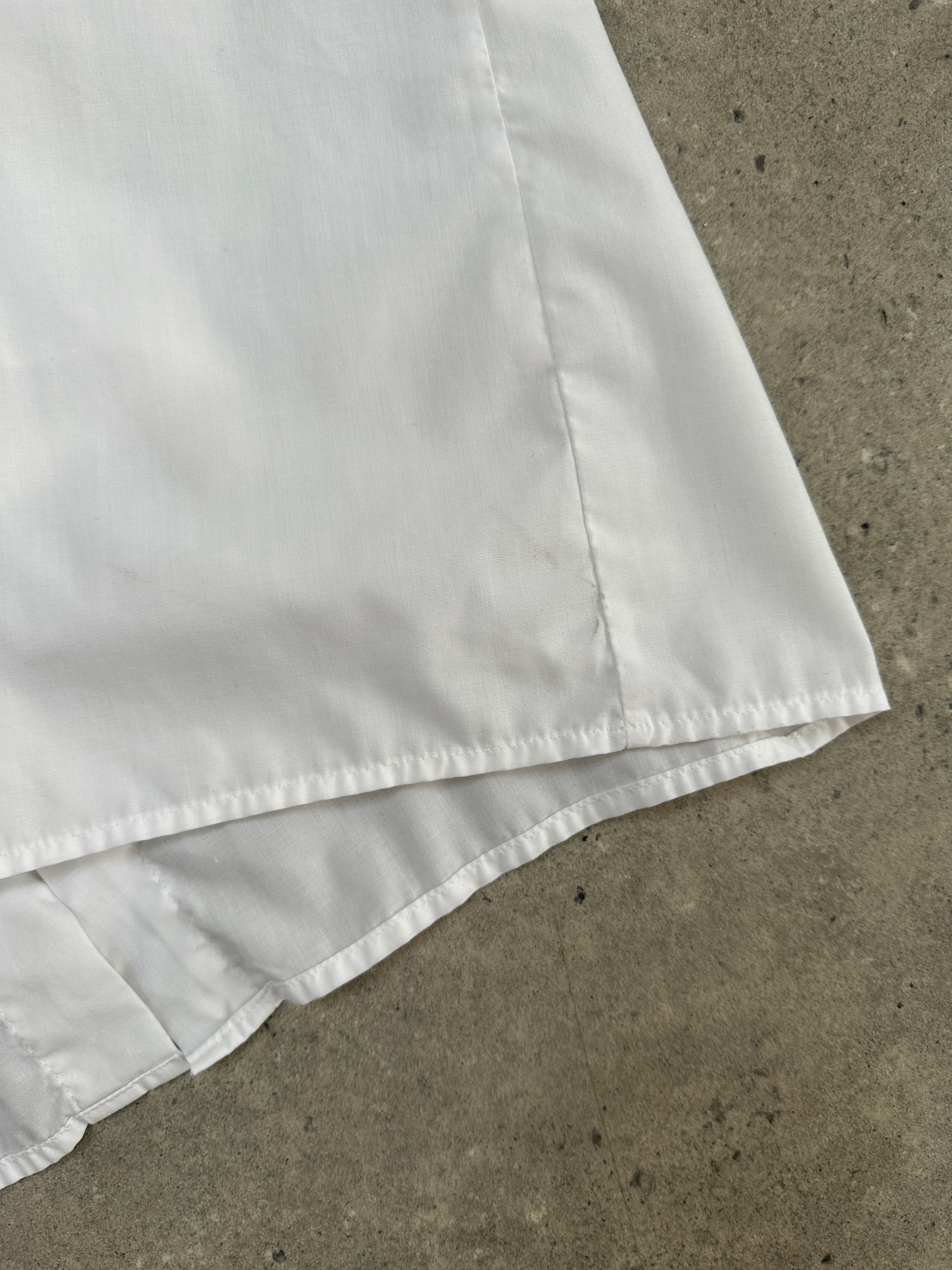 Vintage cotton tuxedo dress shirt in size L, featuring classic collar and button-front design, displayed on a neutral background.