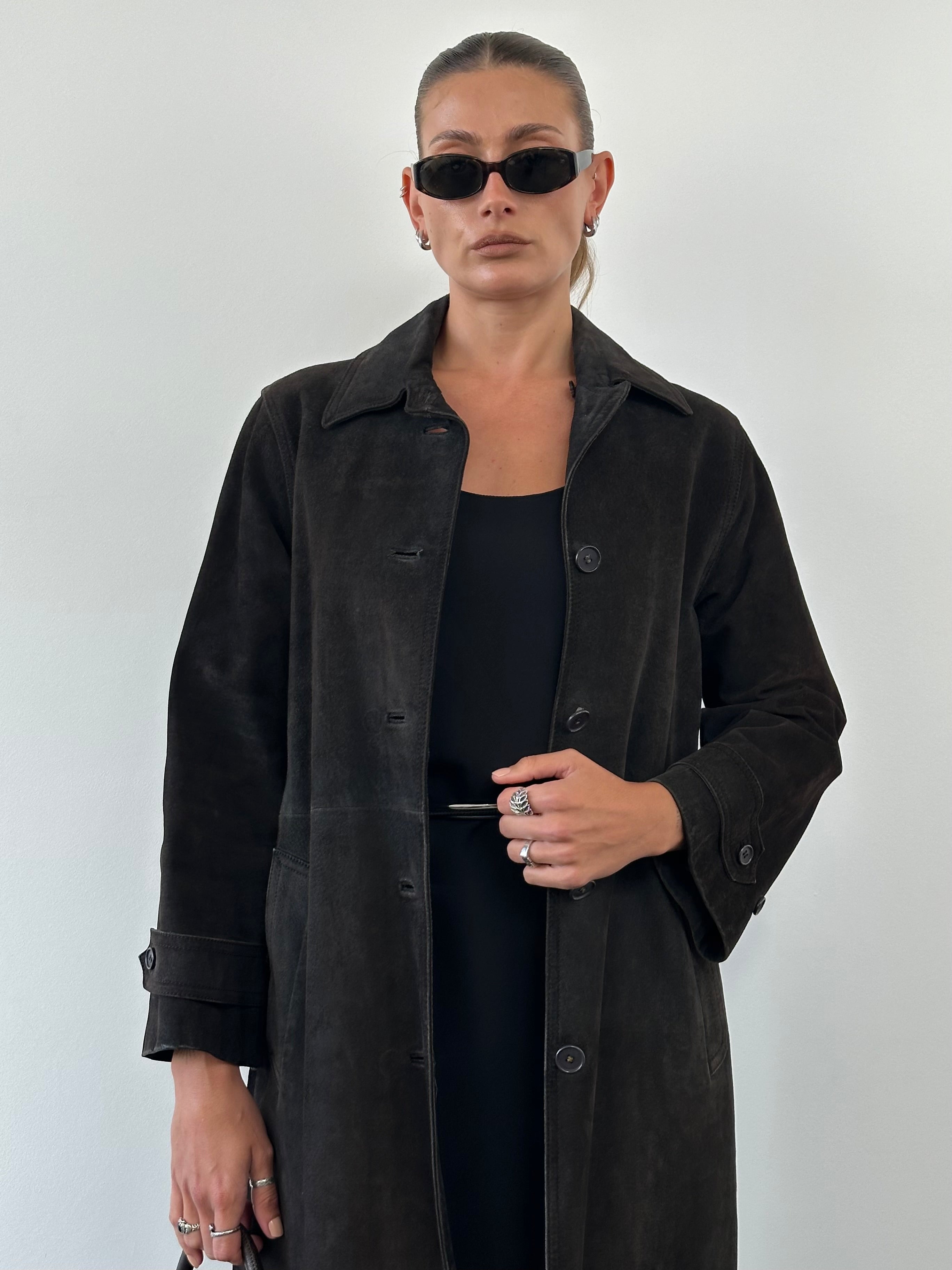 Vintage suede trench coat jacket in size M/L, featuring classic style and earthy tones, displayed on a hanger.