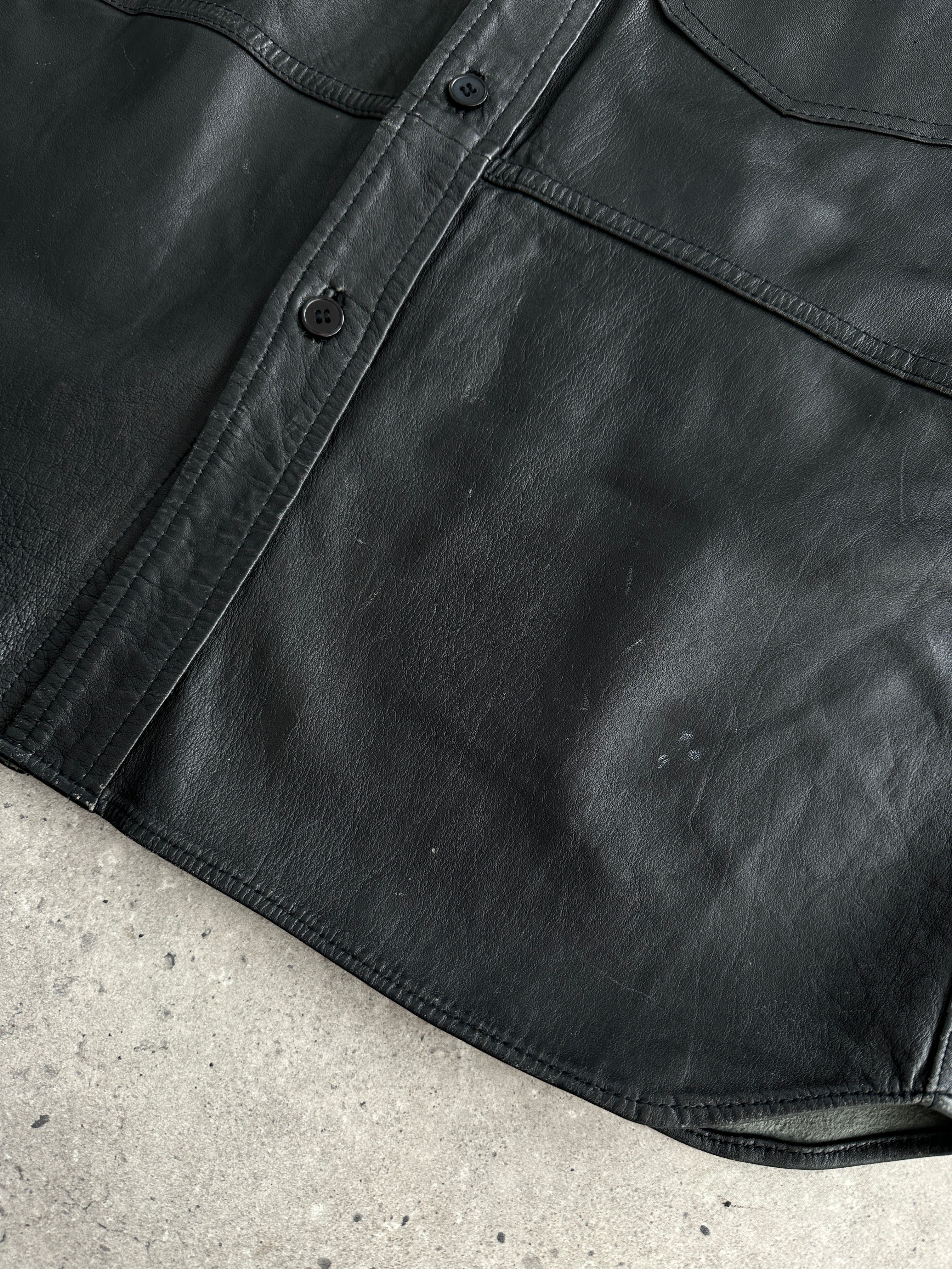 Vintage leather shirt in size large/extra large, featuring a classic design with visible leather texture and stitching details.