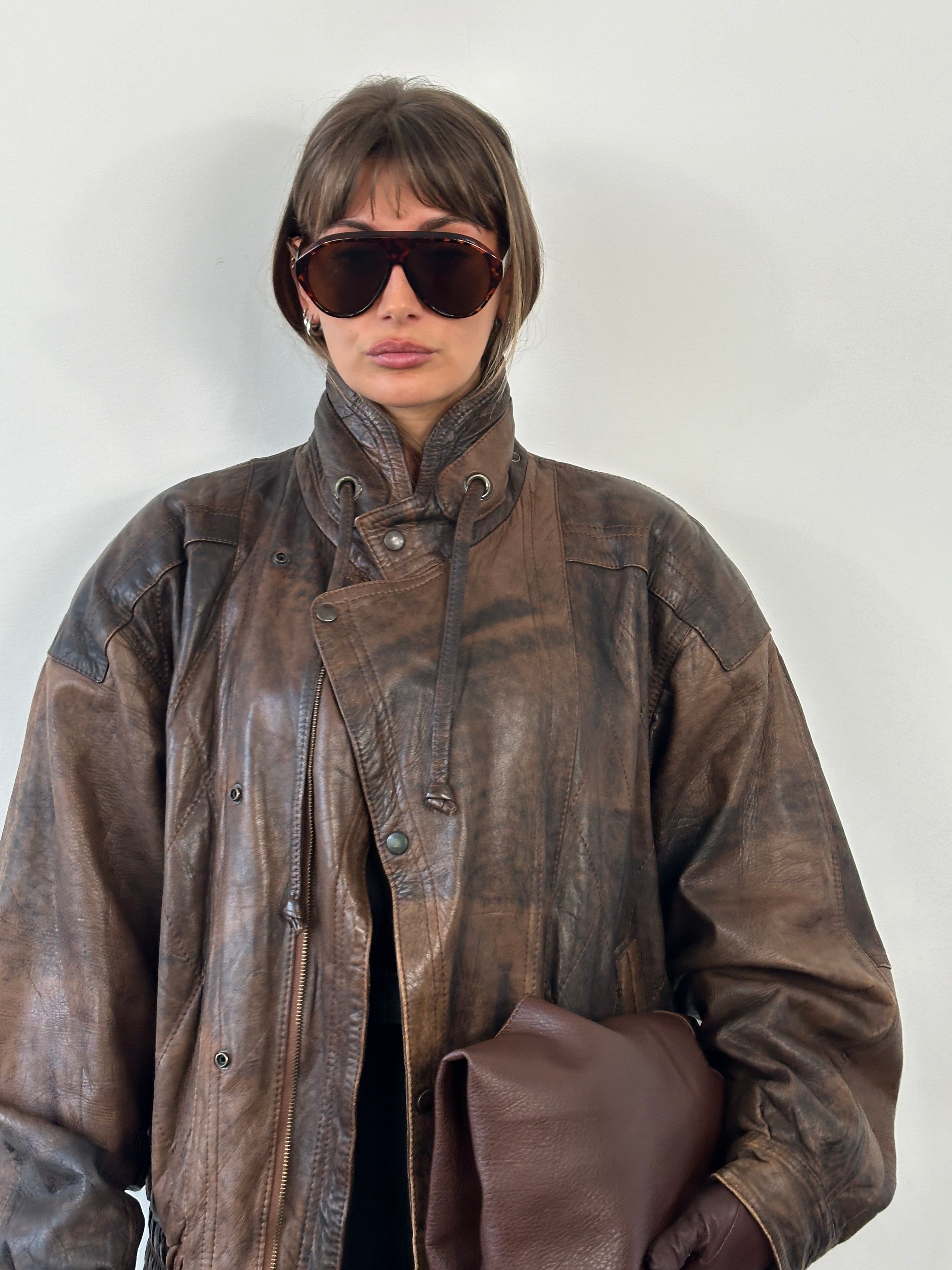 Vintage 1990s high neck aged leather bomber jacket in XL, featuring distressed leather and classic design details.