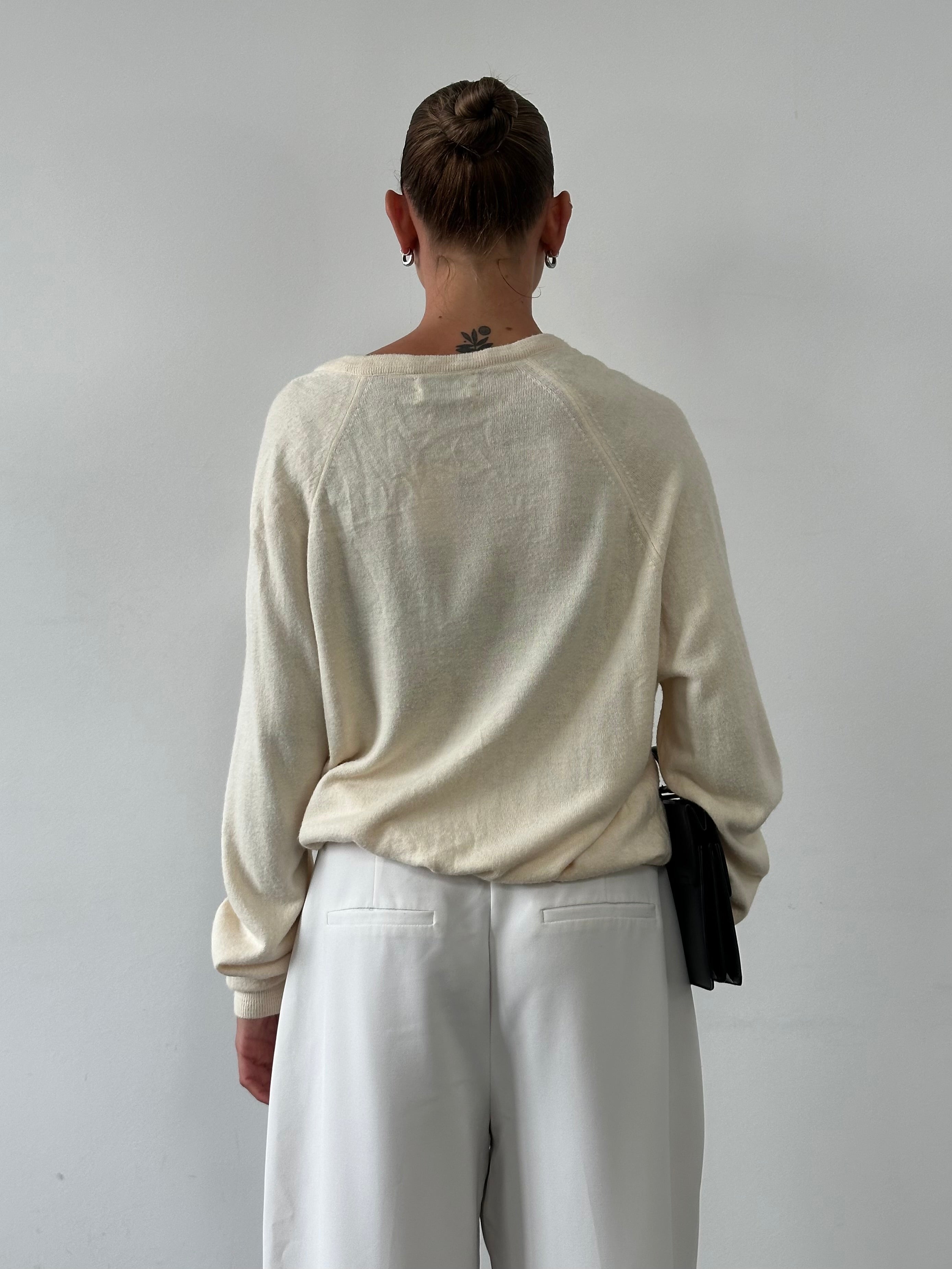 Christian Dior 1980s V-neck logo knitted jumper in size L/XL, featuring a classic design with Dior branding and a textured knit pattern.
