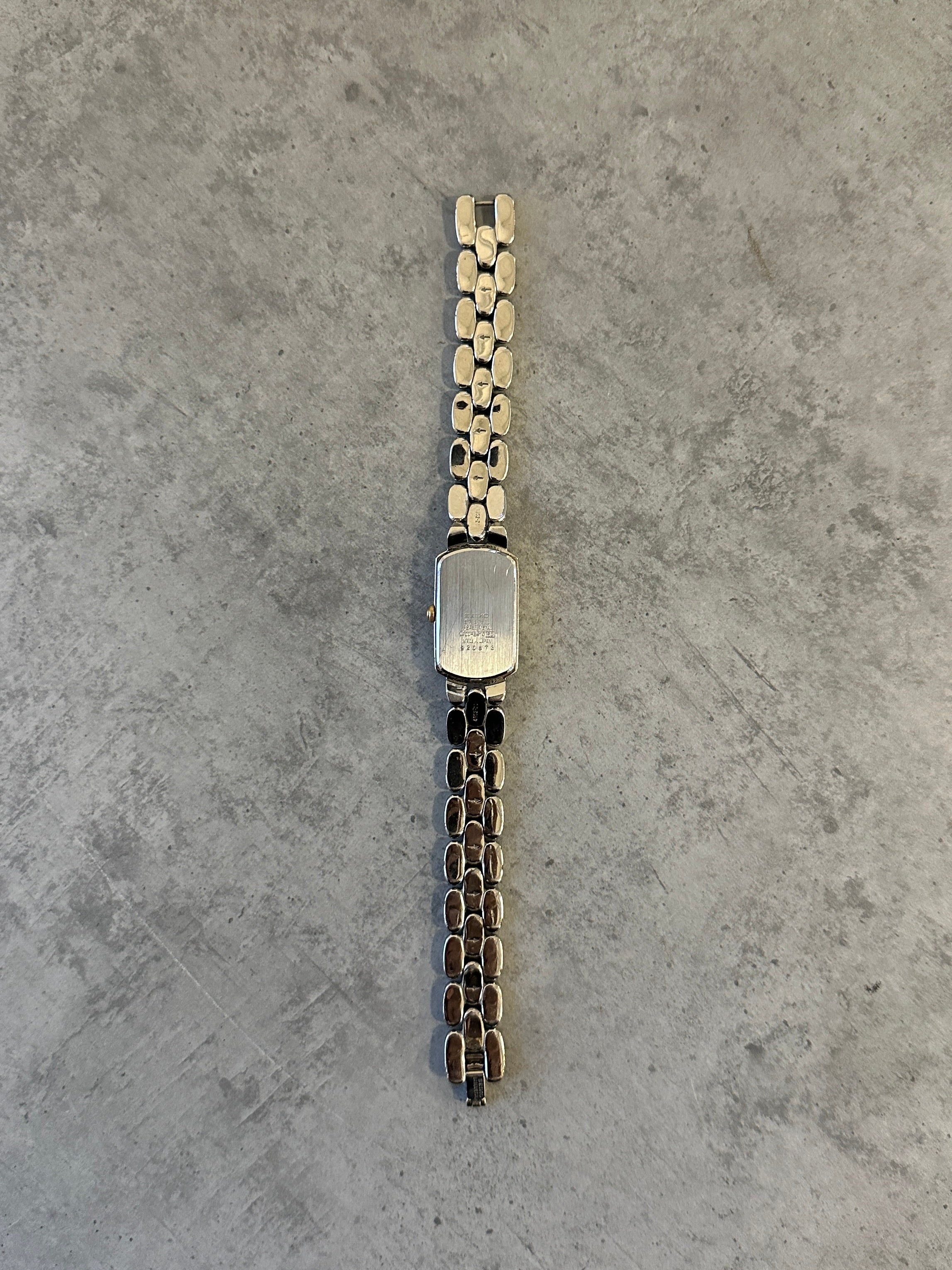 Seiko 1990s stainless steel rectangular quartz watch with a silver dial and metal bracelet.