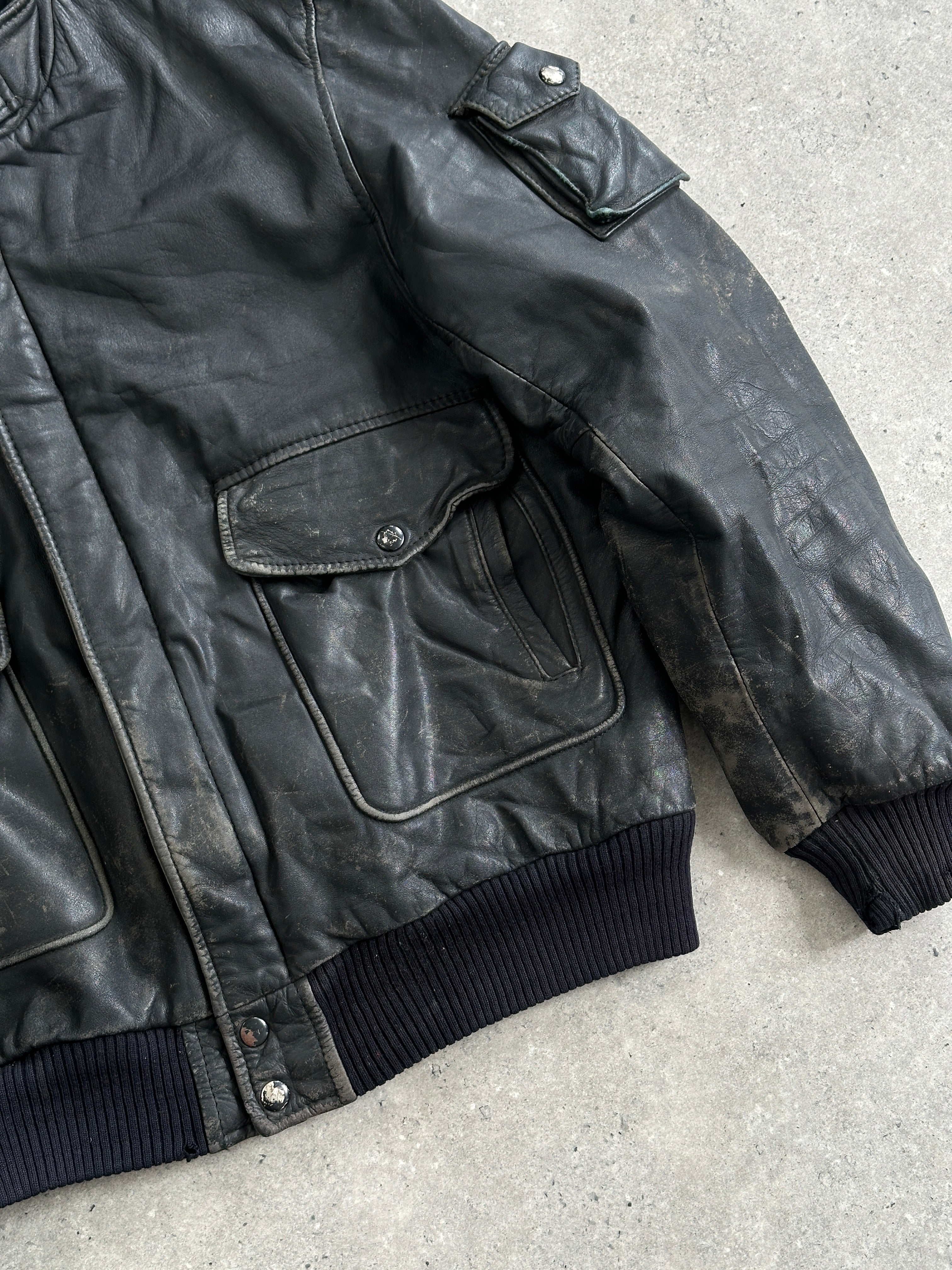 Vintage distressed leather bomber jacket in M/L size, featuring classic style and rugged texture.