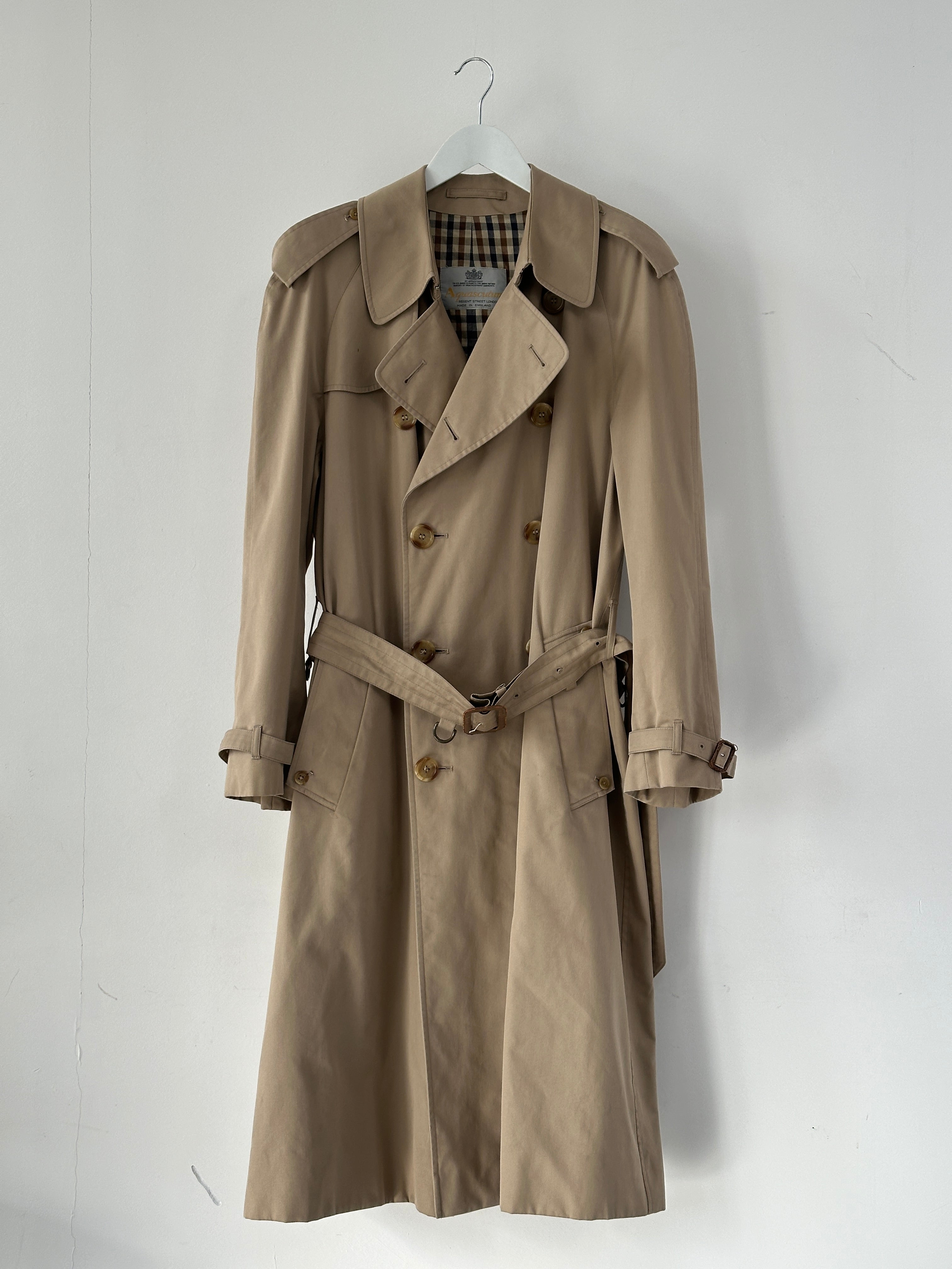 Aquascutum cotton double-breasted belted trench coat in XL, shown on a hanger with classic design and neutral color.