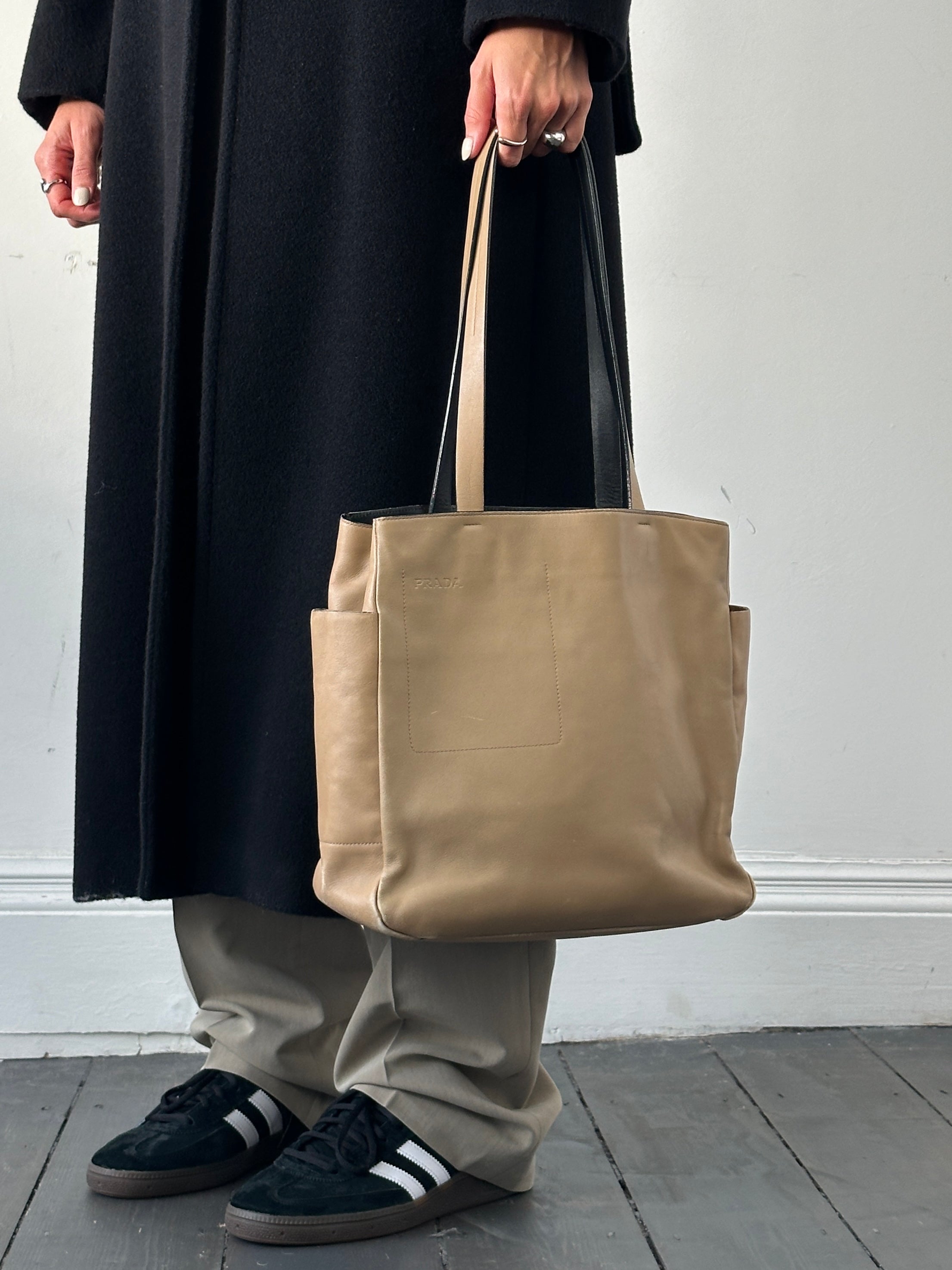 Prada contrast leather tote bag with sleek design, featuring sturdy handles and spacious interior for everyday use.