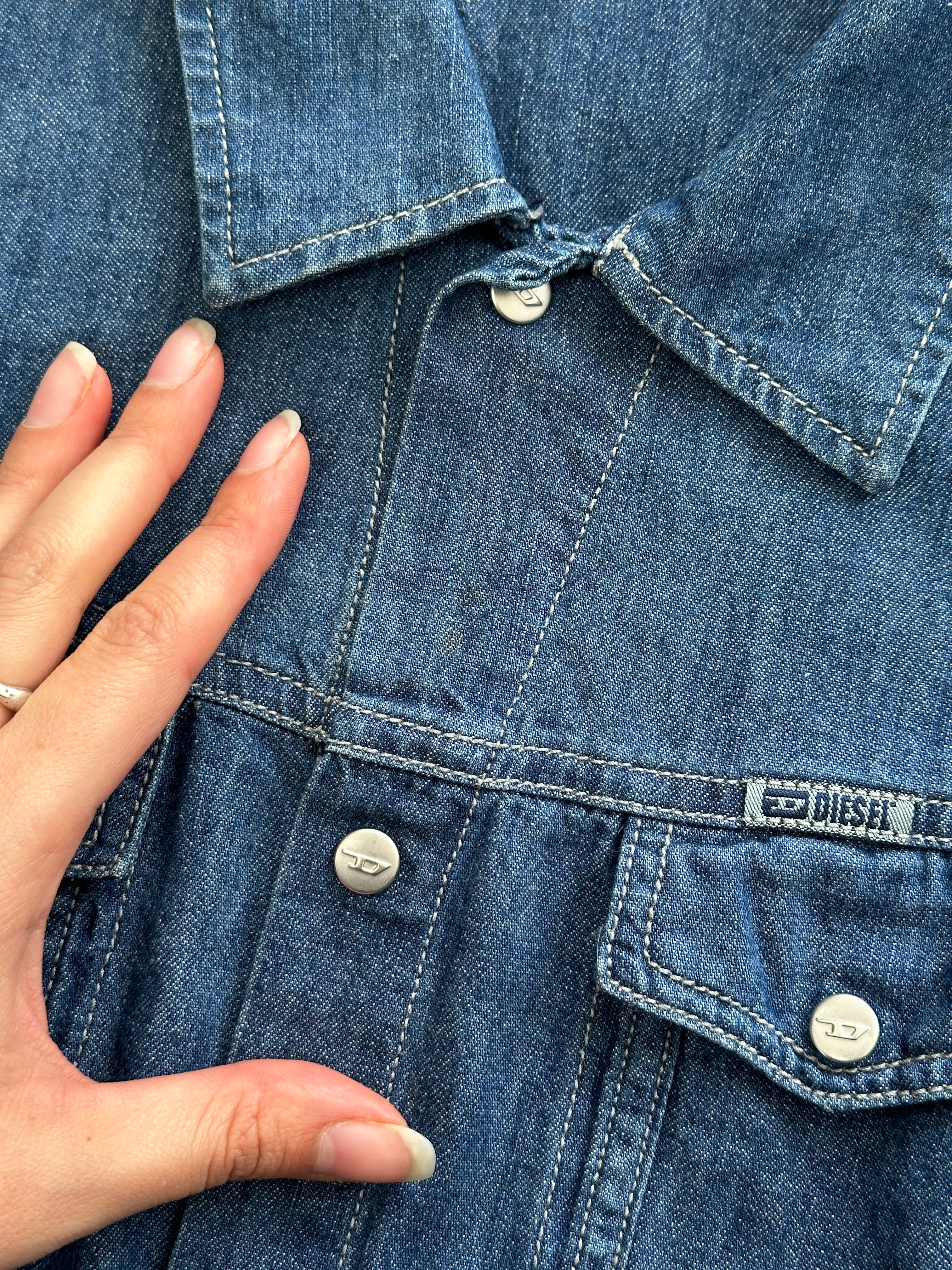 Diesel fitted denim shirt in size small displayed on a hanger, showcasing classic blue denim and button-up front.
