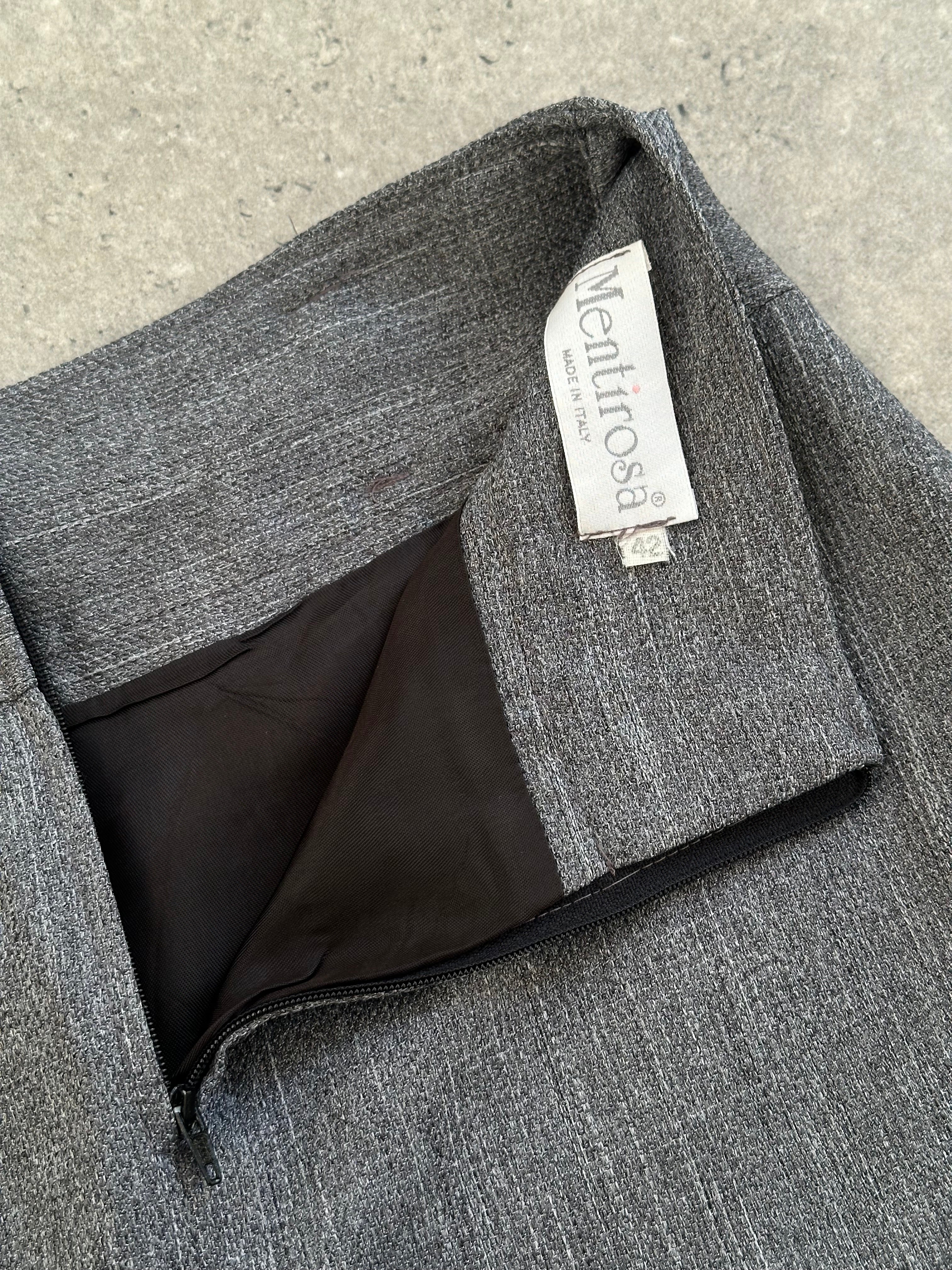 Italian vintage 1990s mini skirt, W25, made of classic fabric, showing the skirt's fitted silhouette and retro style.