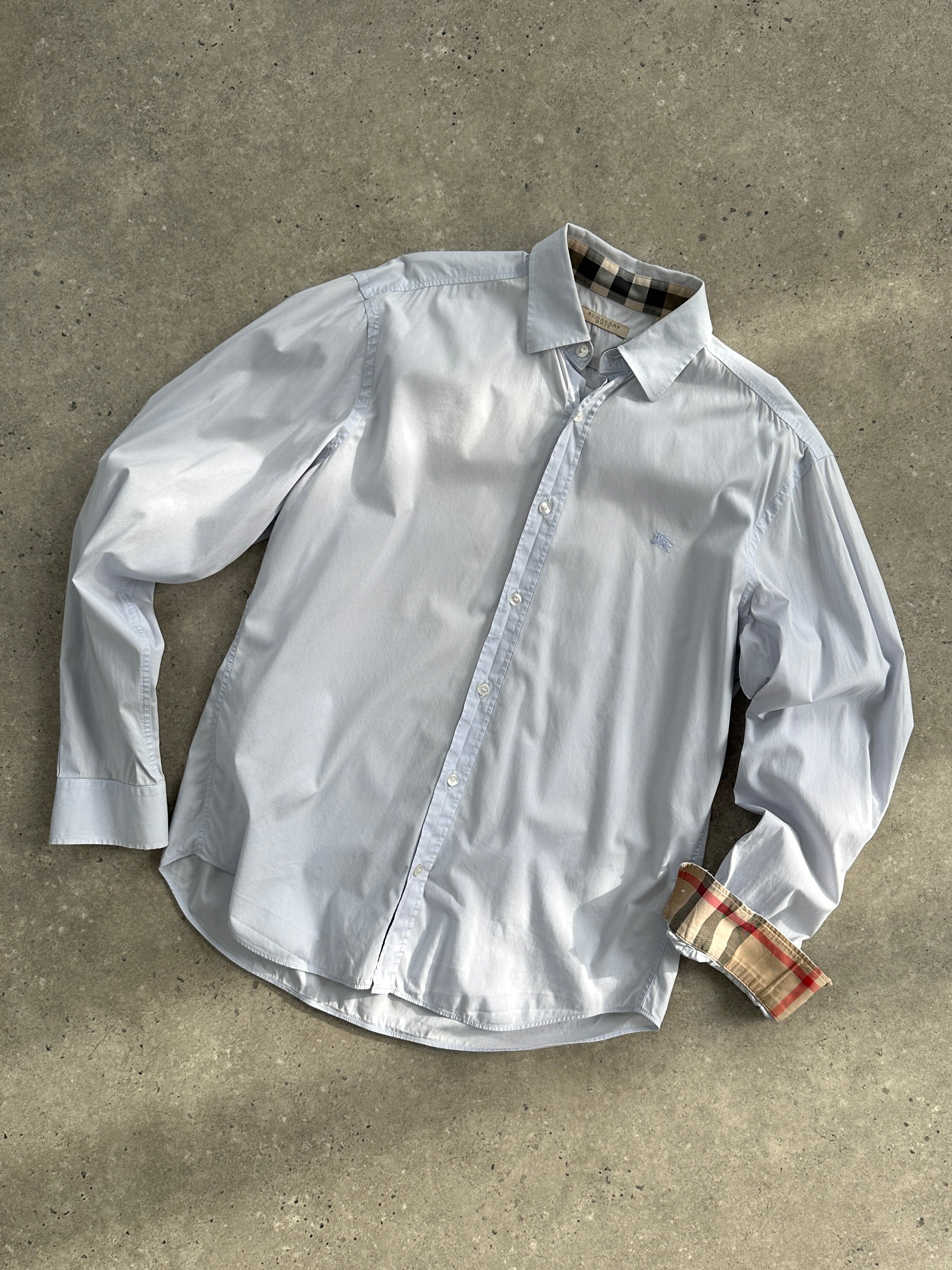 Burberry Brit cotton logo shirt in size M, featuring the classic branded design and button-down style, displayed on a hanger.