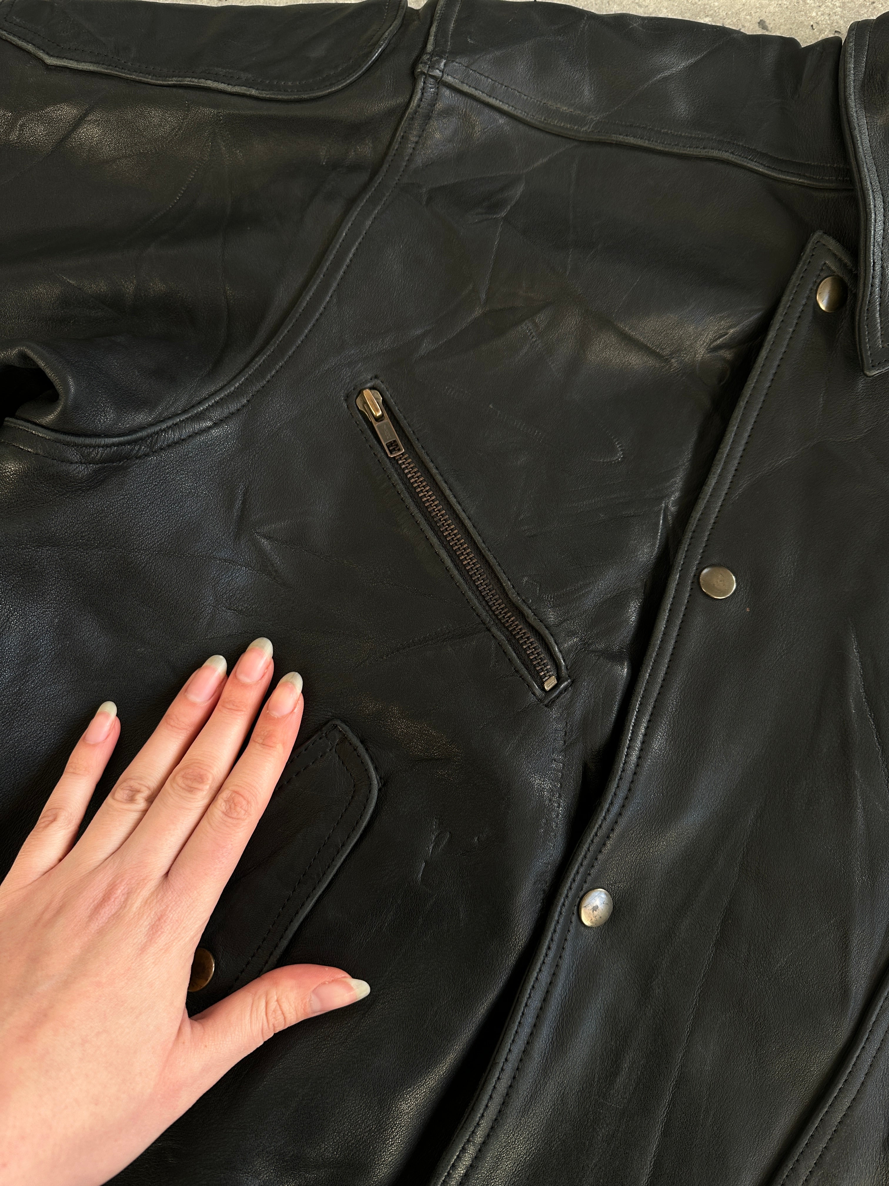 Vintage leather jacket in size XL, showcasing classic design and distressed brown leather material.