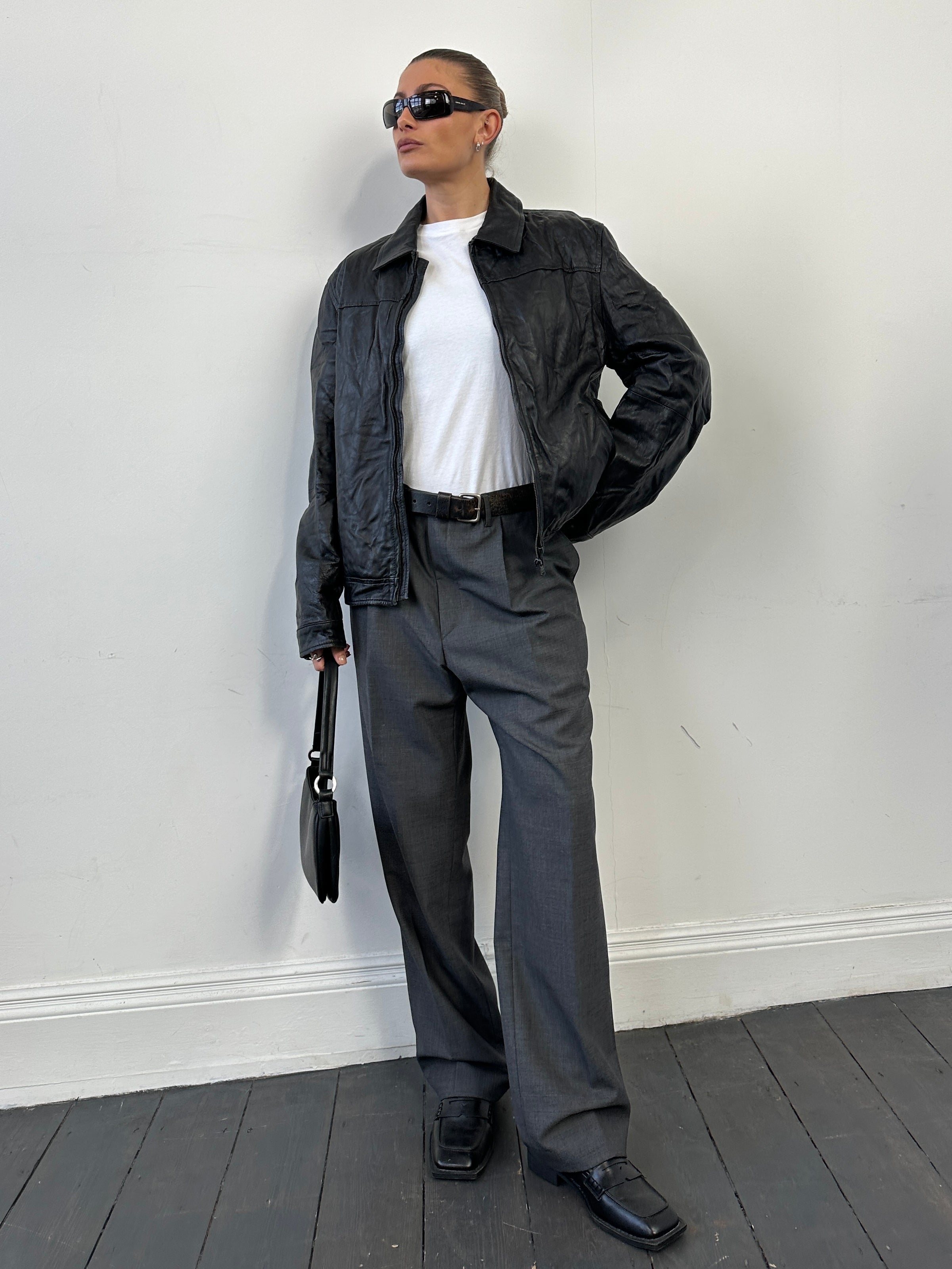 Vintage men's zip-up leather jacket, stylish and classic, featuring a front zipper and tailored fit.