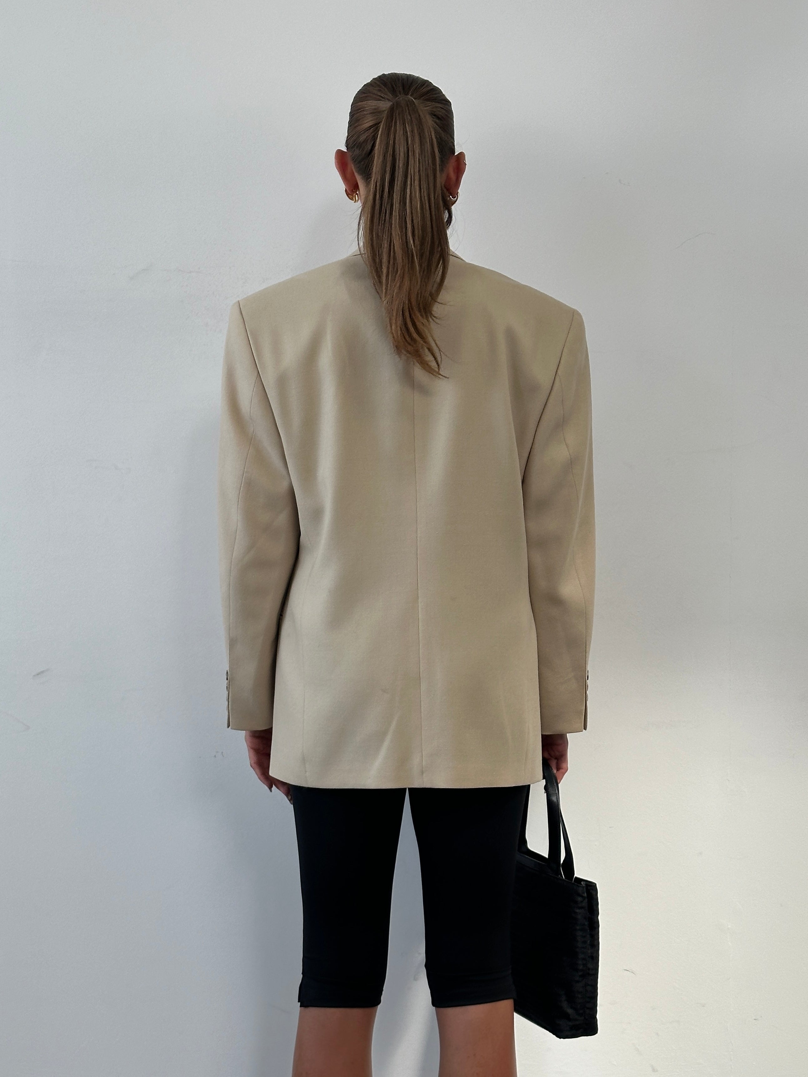 Vintage wool double-breasted blazer in size 40R/L, featuring classic design and tailored fit, displayed on a neutral background.