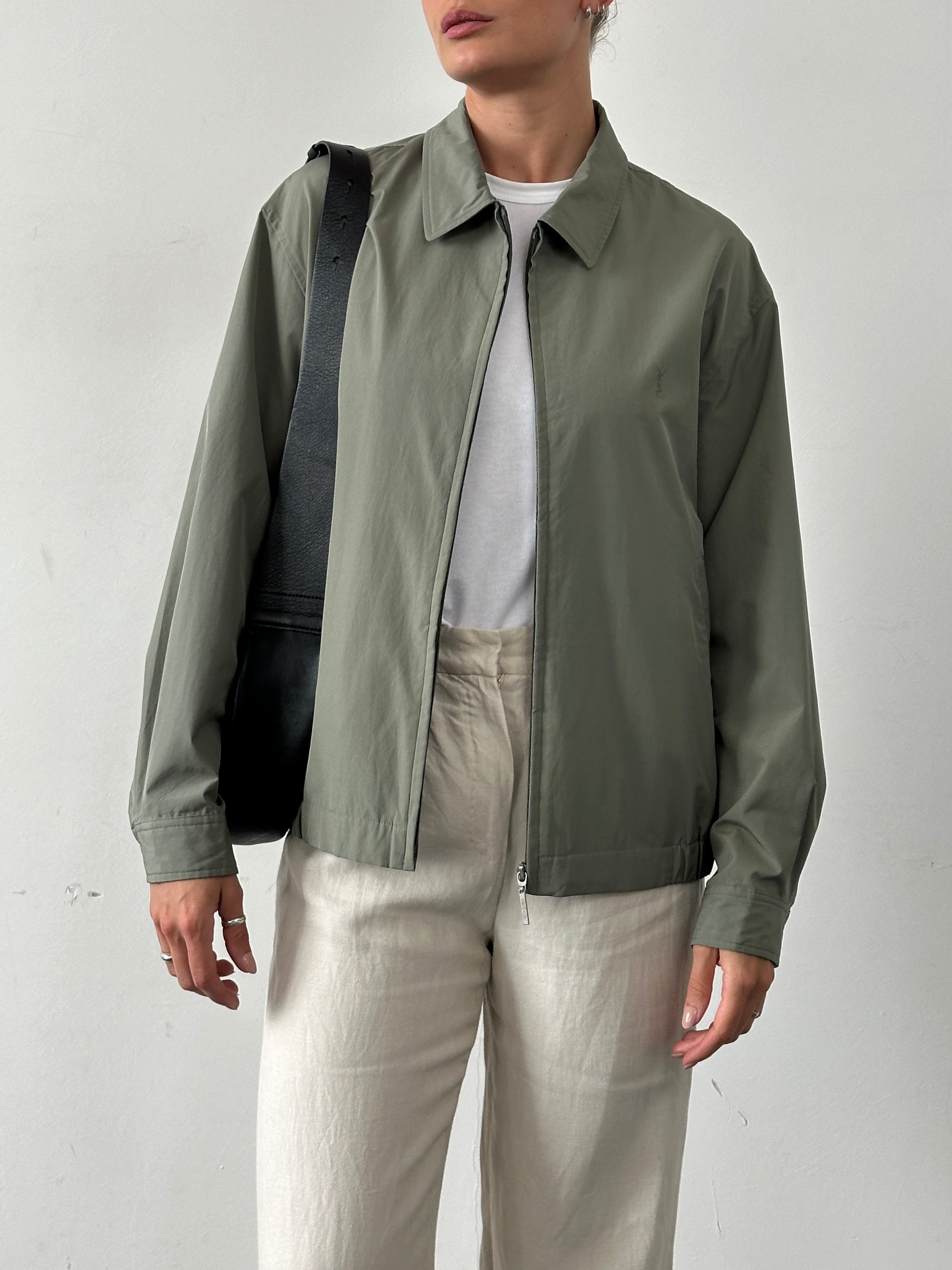 Yves Saint Laurent Pour Homme logo bomber jacket in black, front view showing the signature YSL logo on the chest.