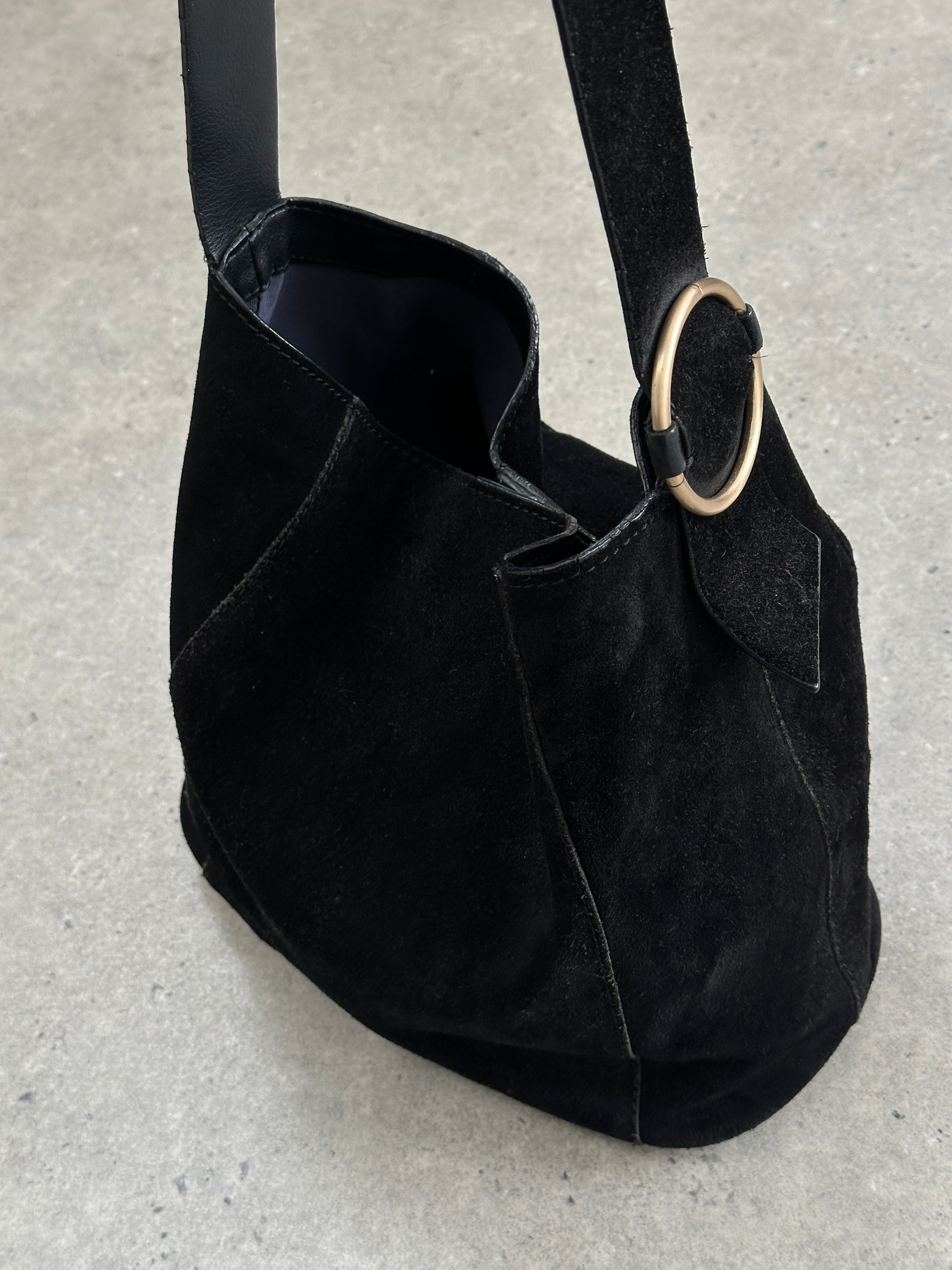 Vintage Maison de Nimes suede bucket bag with drawstring closure and shoulder strap, displayed against a neutral background.