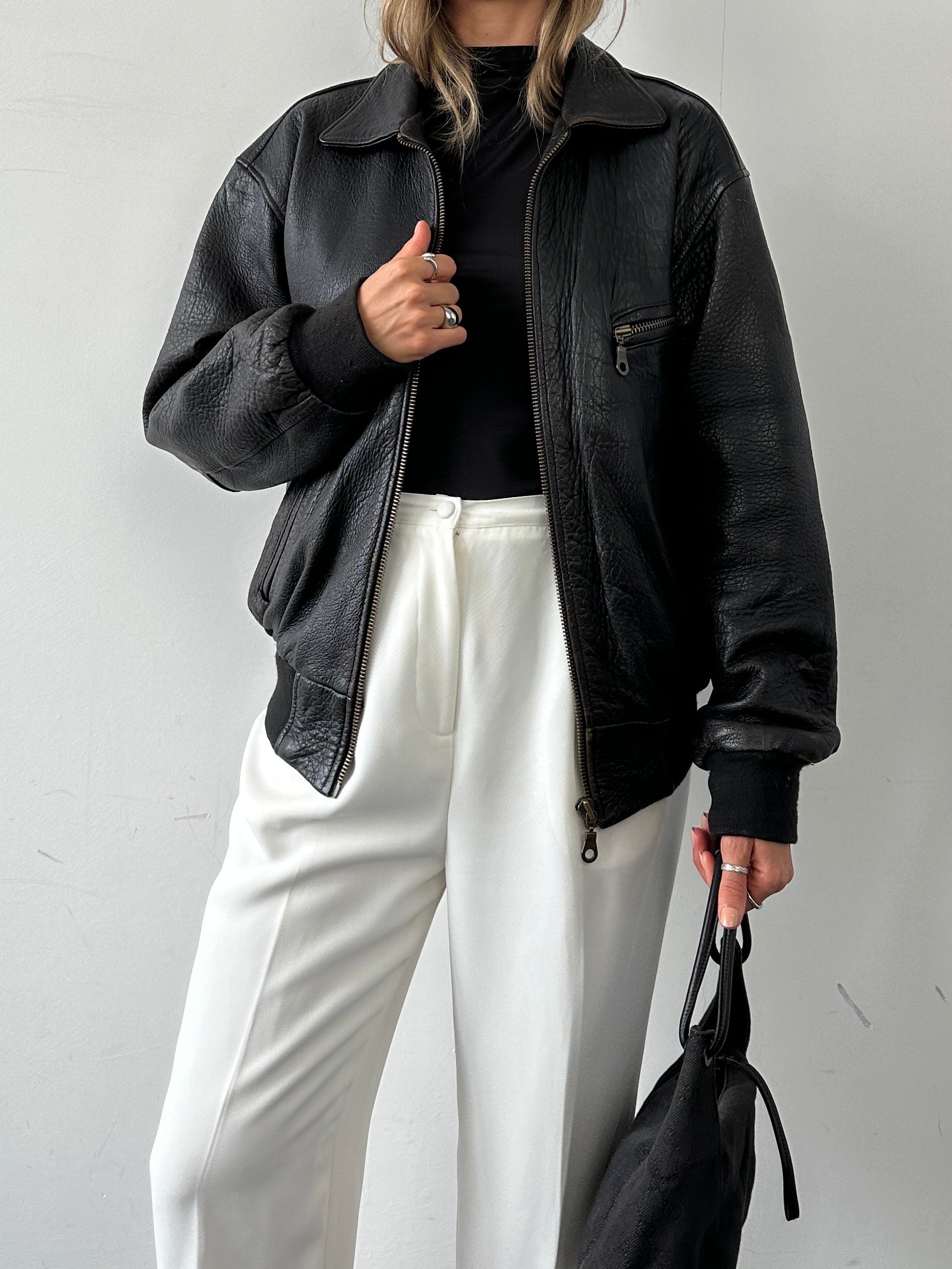 Vintage British leather bomber jacket in size M with classic design, featuring a rugged leather exterior and vintage-inspired style.