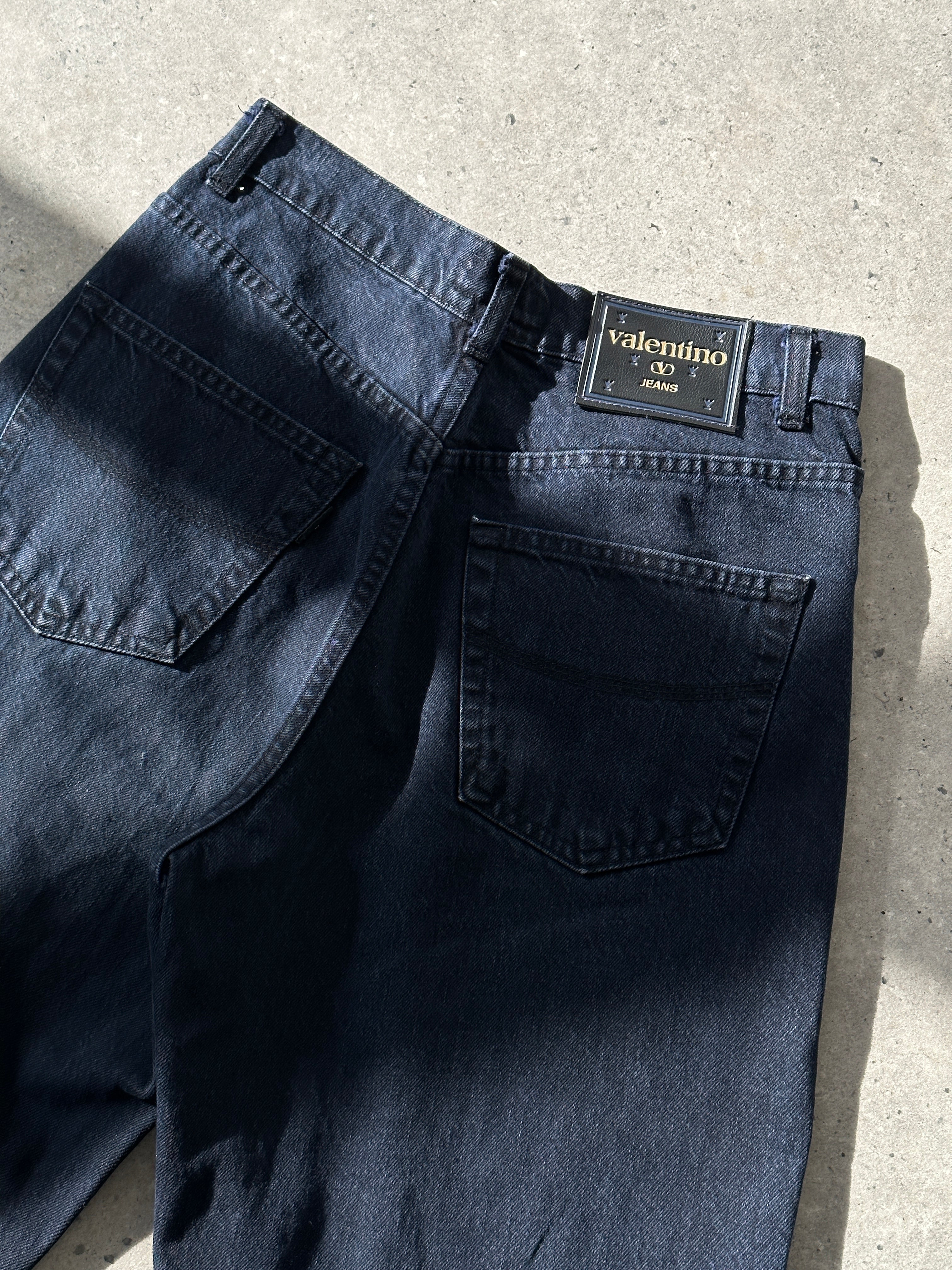 Valentino tapered high waisted denim jeans in W28, featuring classic blue wash and modern fit, displayed on a neutral background.