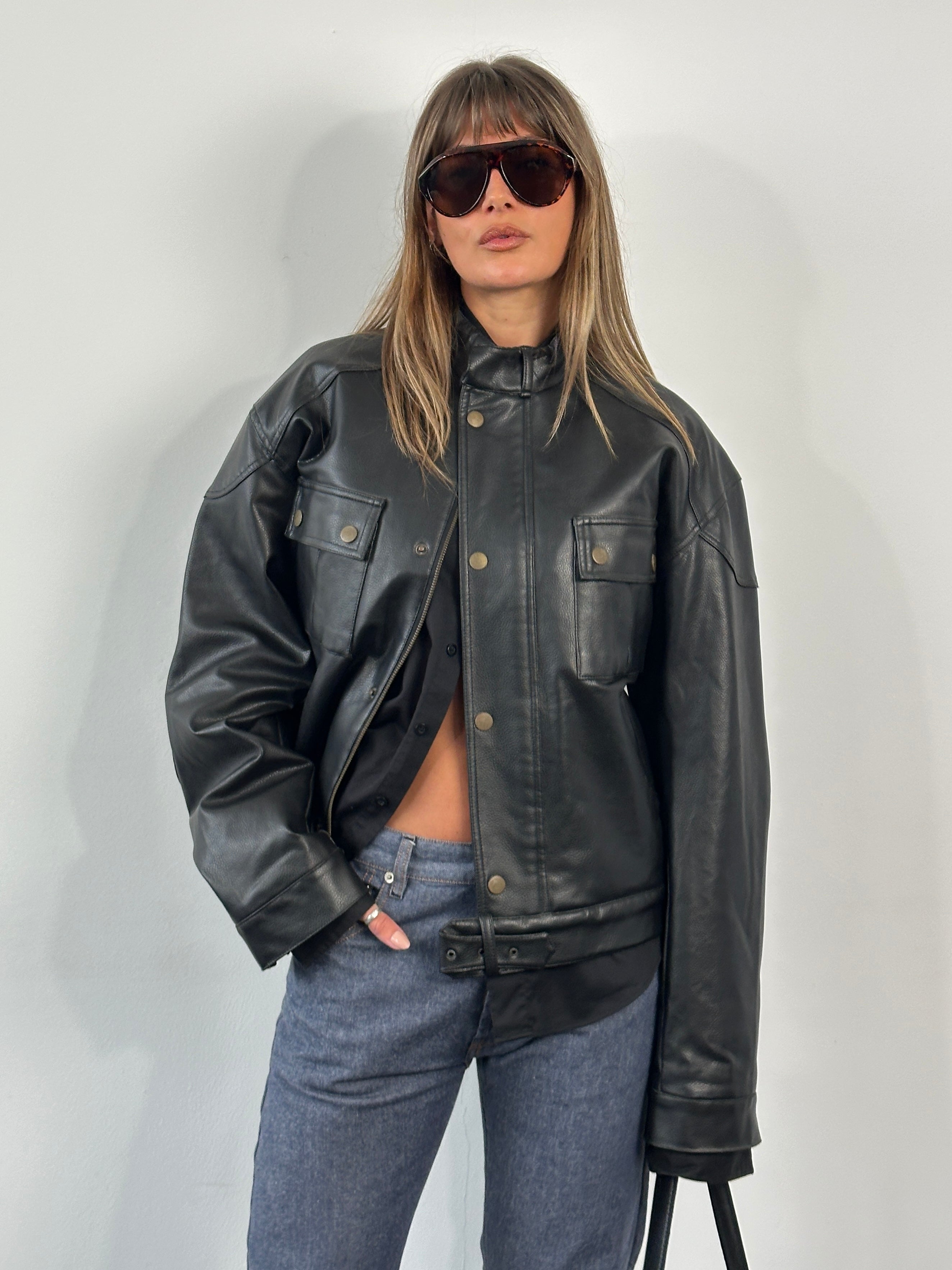 Vintage 1990s boxy faux leather jacket, size M, with classic design and textured black faux leather material.