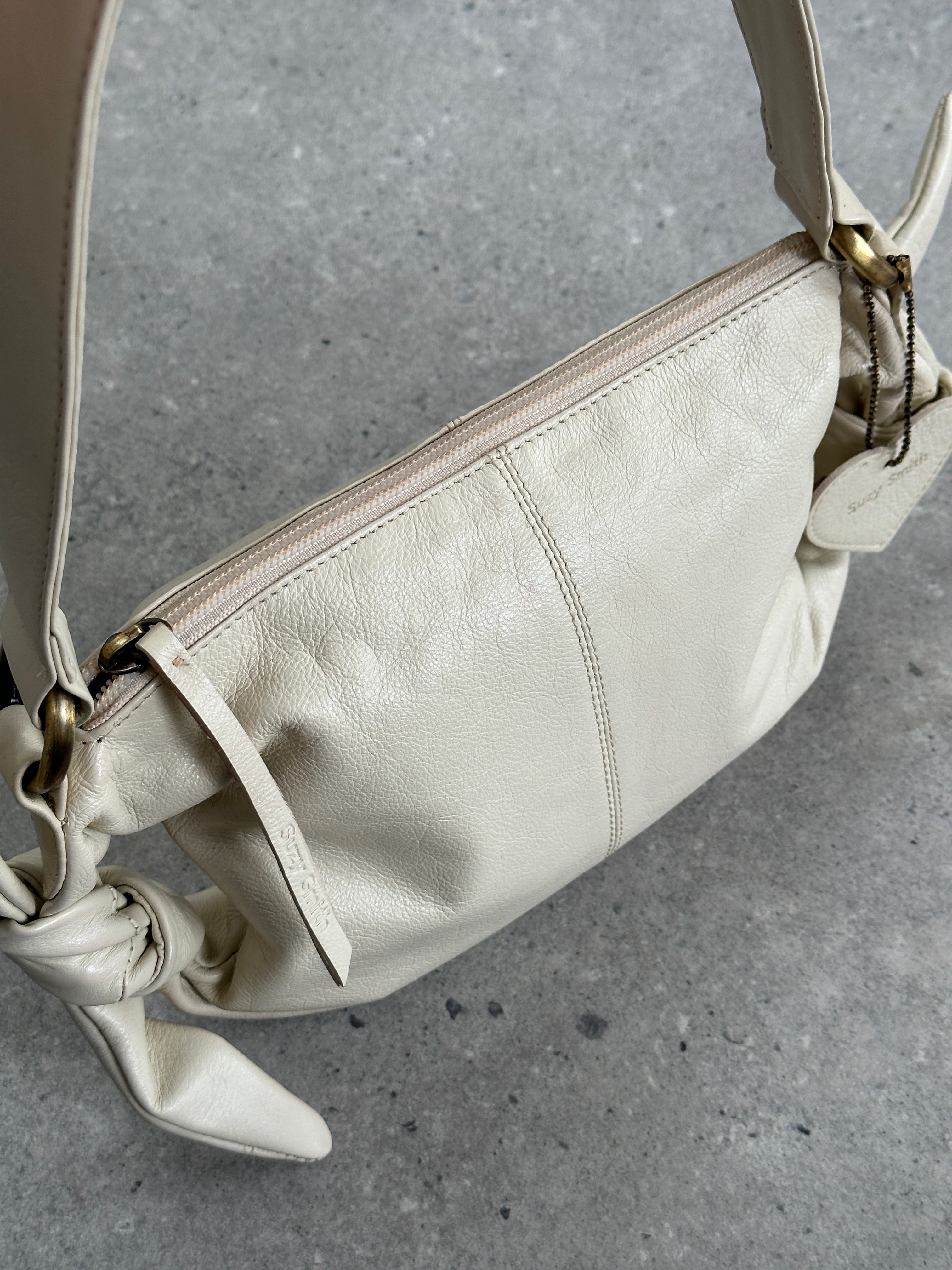 Vintage soft leather knot shoulder bag with a stylish design and adjustable strap, perfect for casual and chic outfits.