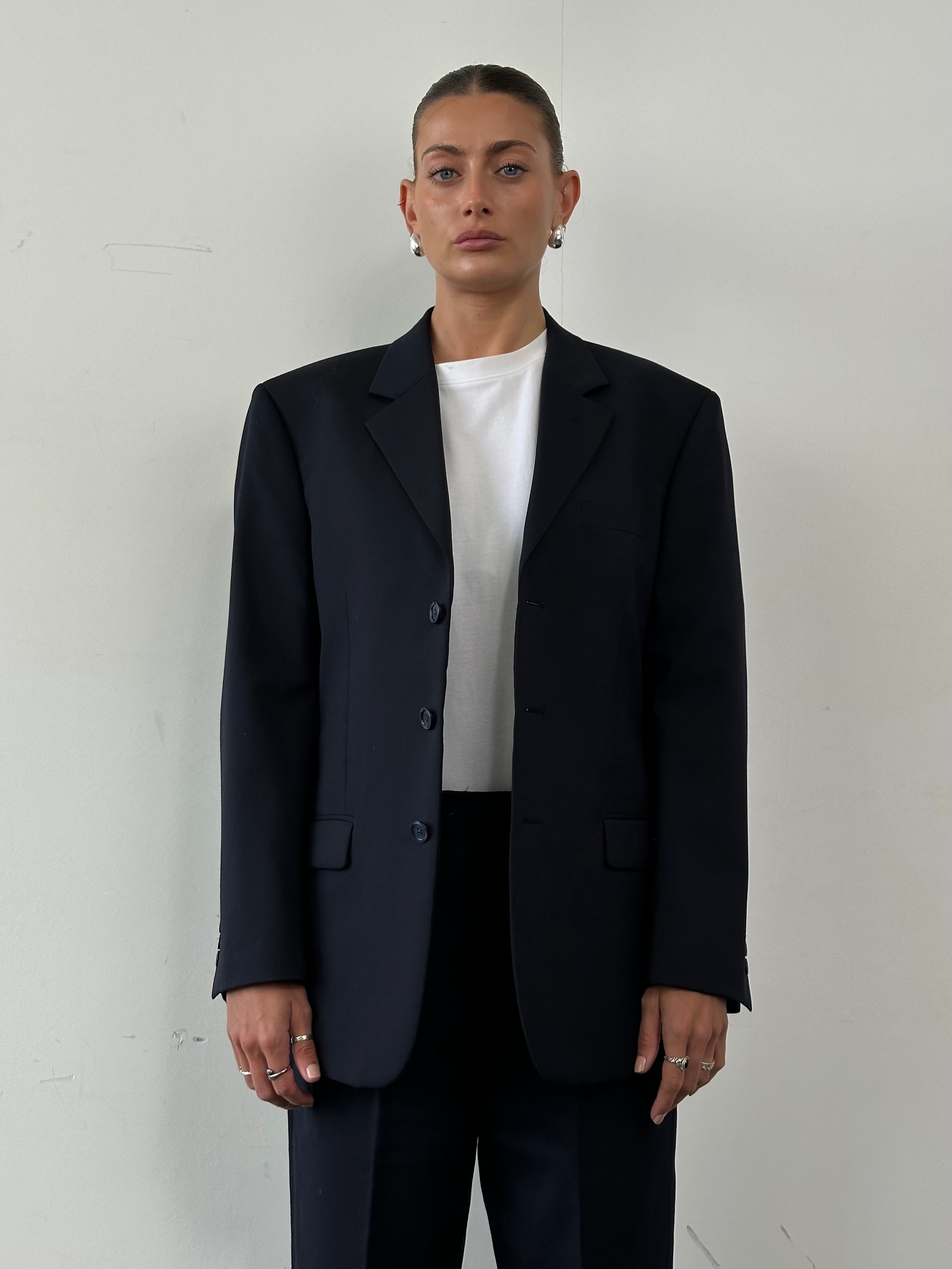 Vintage wool single-breasted blazer in size 38S/L, tailored fit with classic lapels, displayed on a hanger against a neutral background.