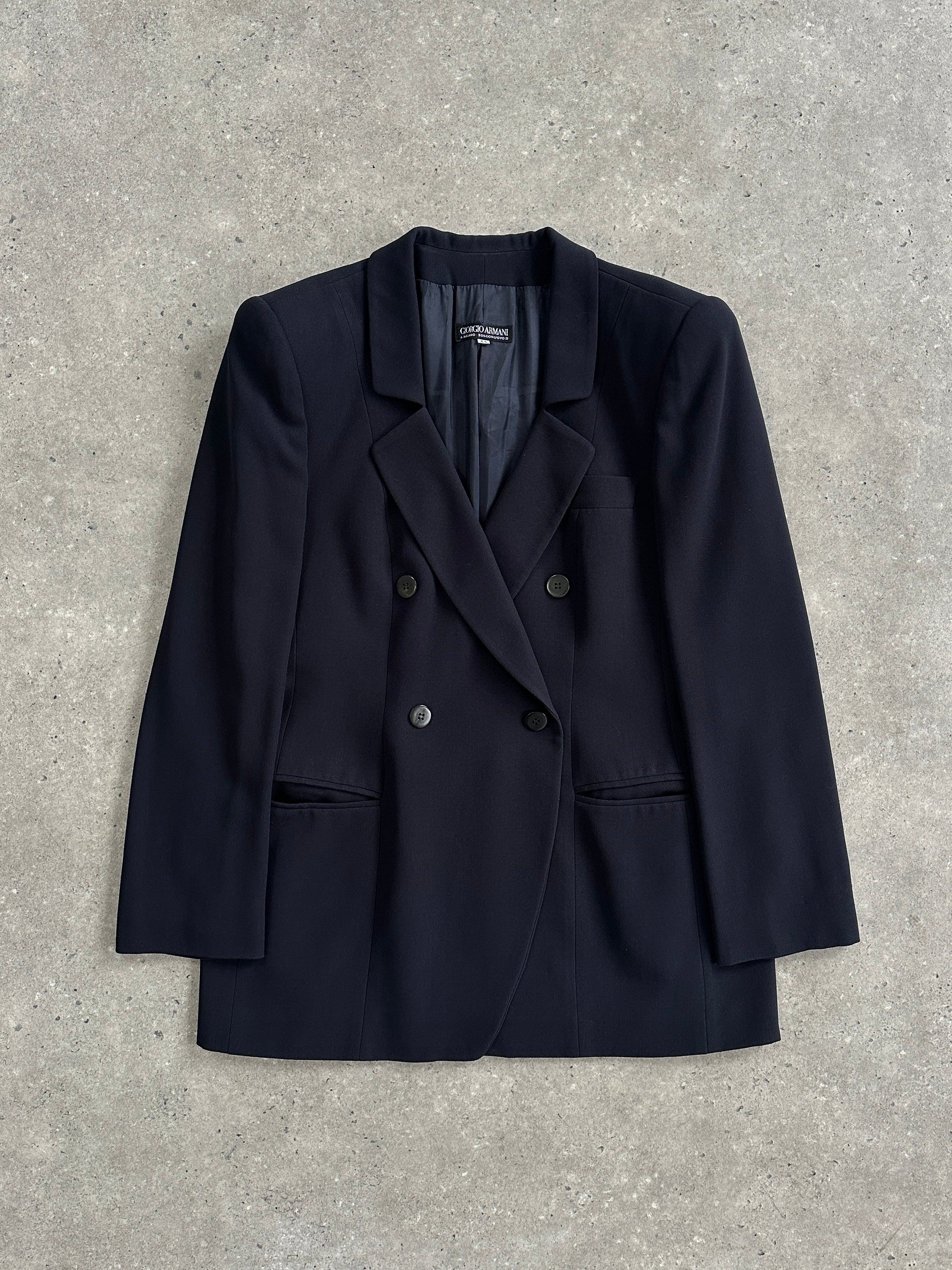 Giorgio Armani Black Label fitted wool blazer in black, displayed on a hanger, showing tailored design and classic lapel details.