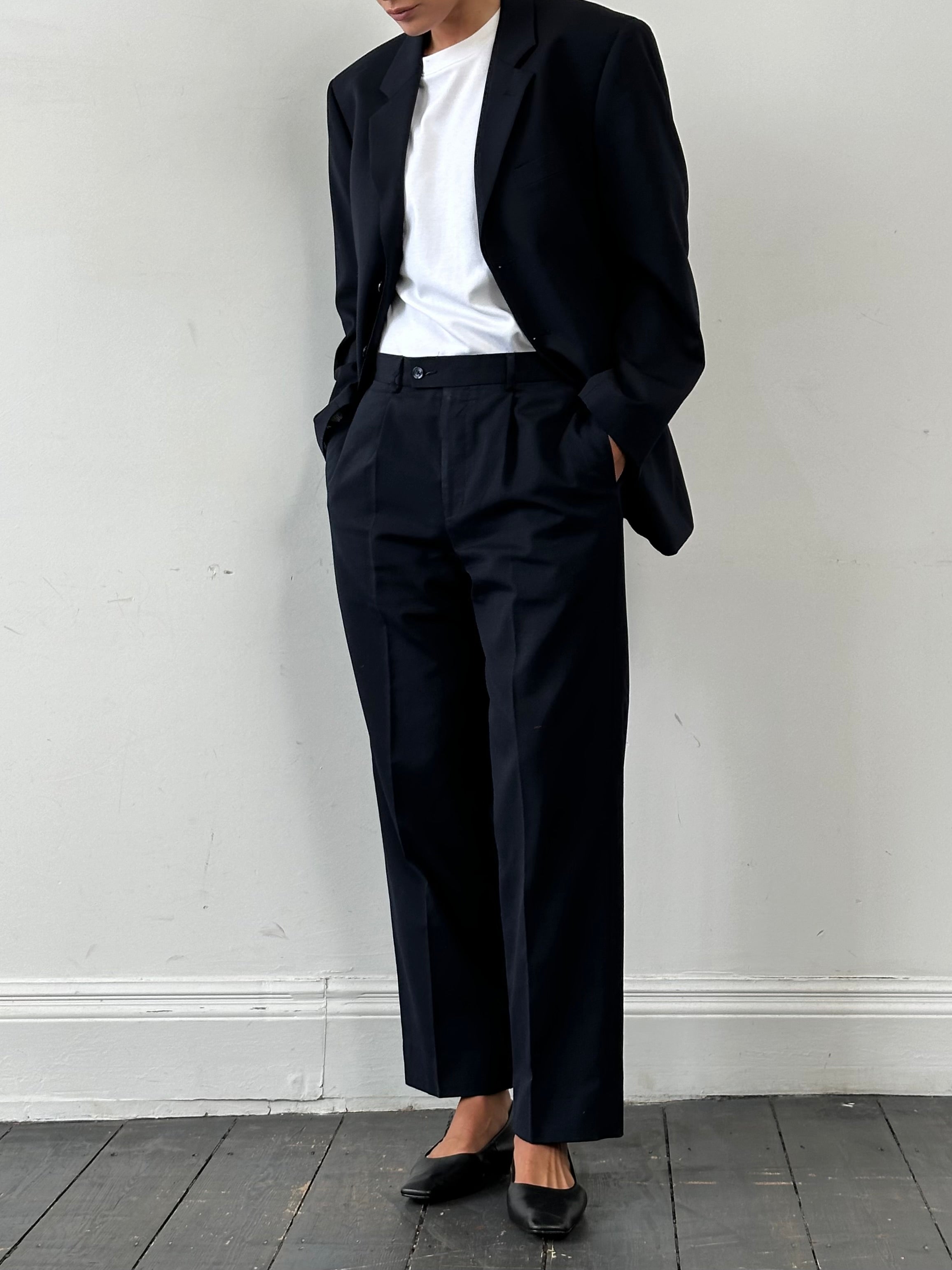 Vintage wool high-waisted straight-leg trousers in neutral color, displayed on a hanger against a plain background.