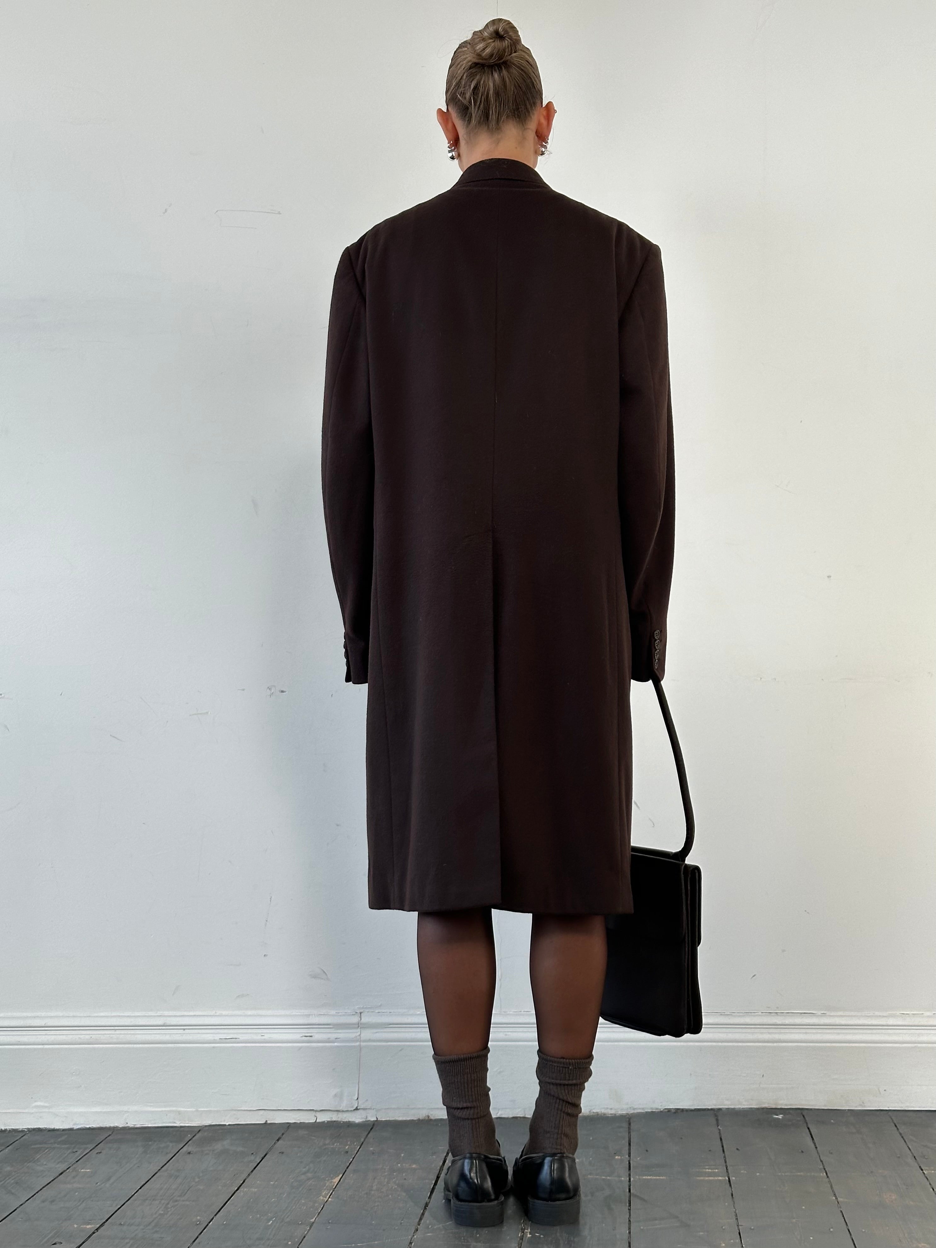 Christian Dior XL wool cashmere double-breasted coat displayed on a hanger, showcasing the tailored design and luxurious fabric.