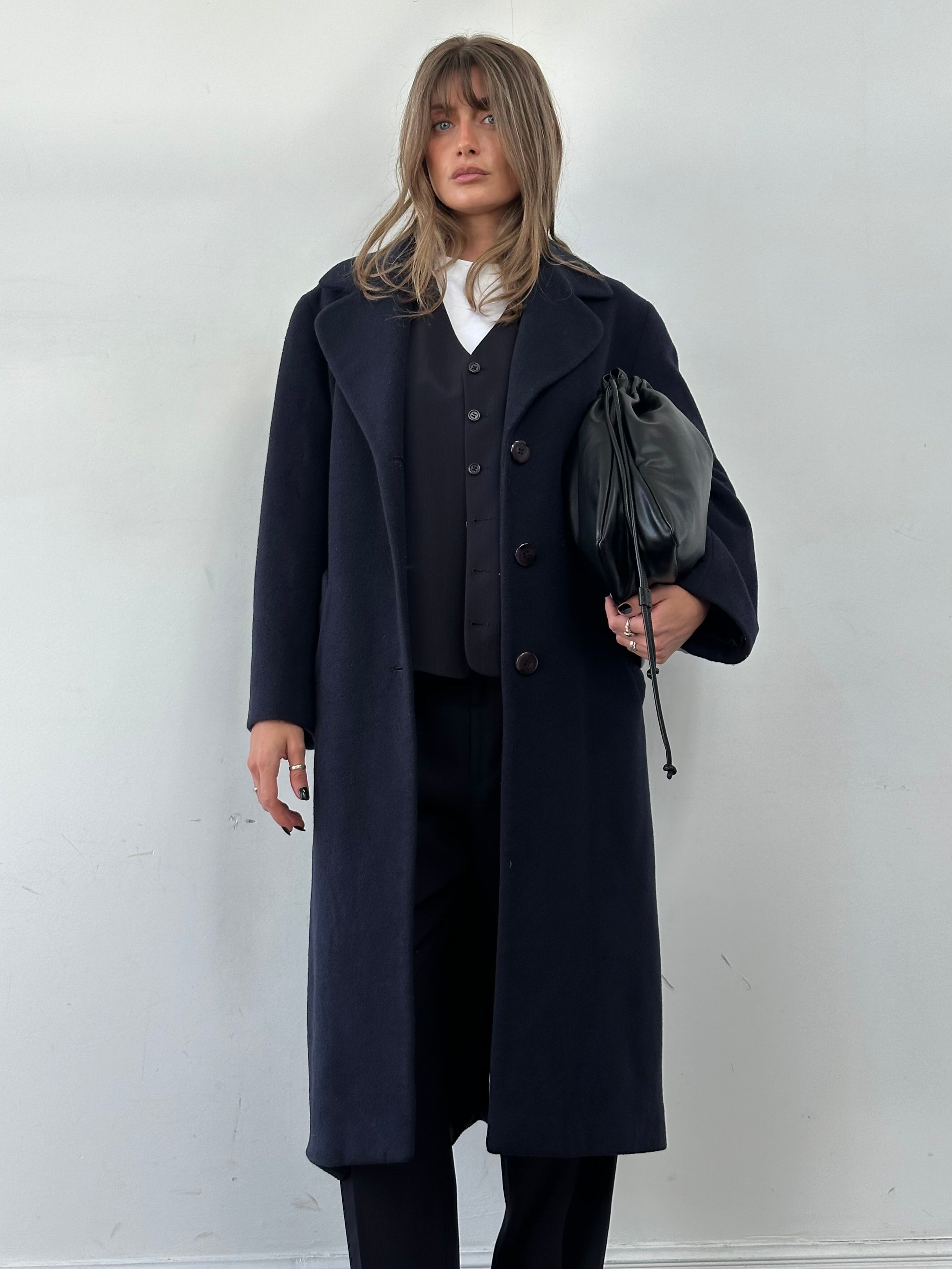 Vintage Virgin Wool single-breasted coat in size M, featuring classic design and textured fabric, displayed hanging on a wooden hanger.