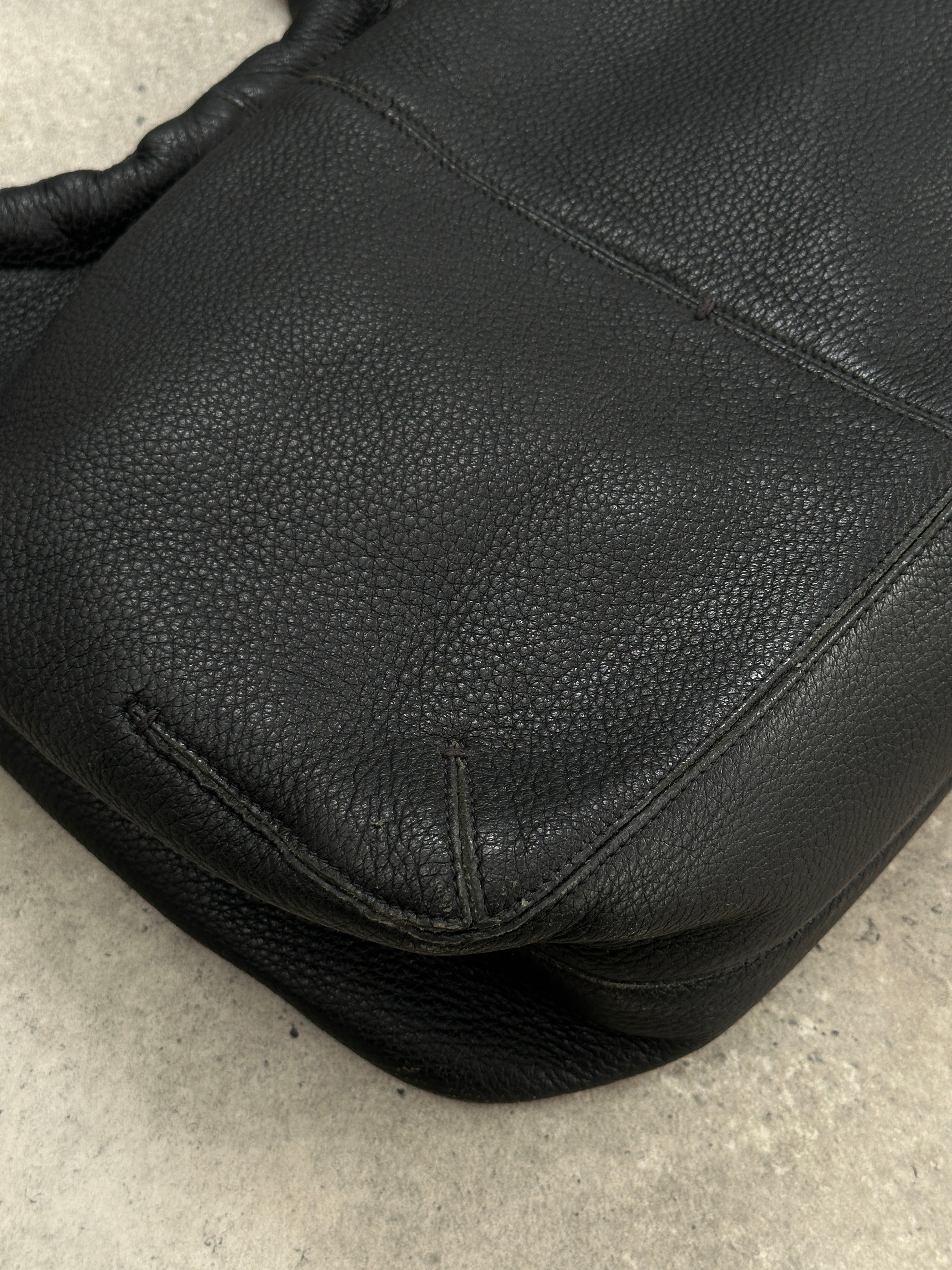 Giorgio Armani leather hobo shoulder bag from the 2000s with a sleek design and spacious interior, featuring a classic brown leather finish.