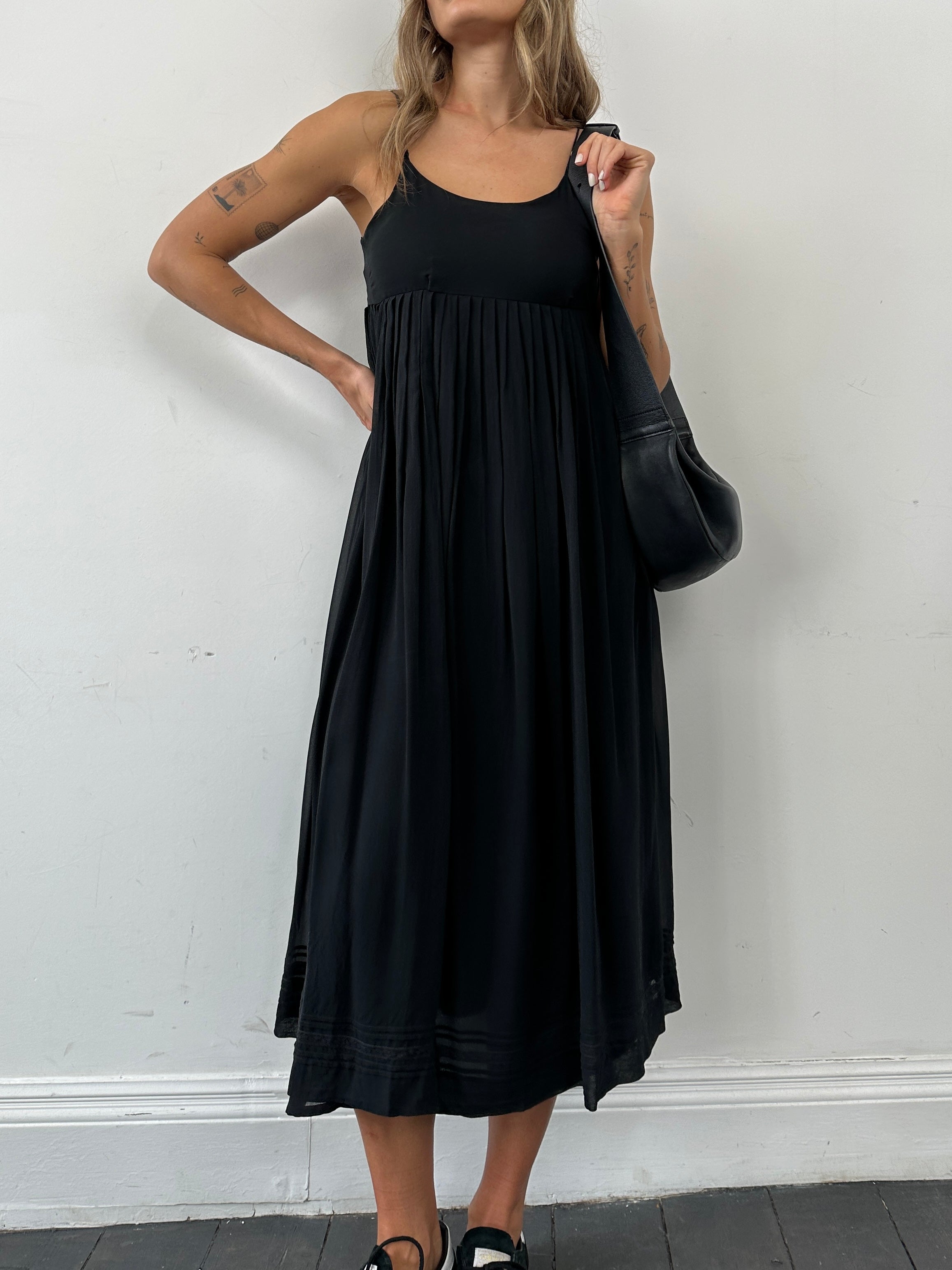 Laura Ashley pure silk pleated slip dress in XS, featuring a flowing design and elegant pleats on a neutral background.