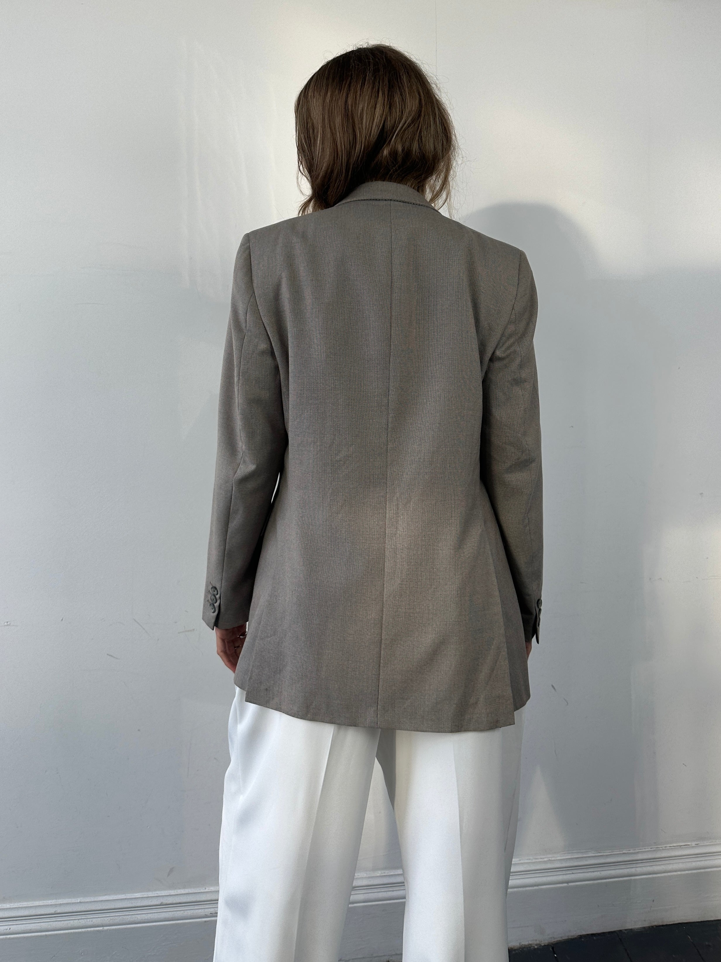 Givenchy wool single-breasted blazer in size M, tailored fit with classic lapels and structured design, shown on a hanger.