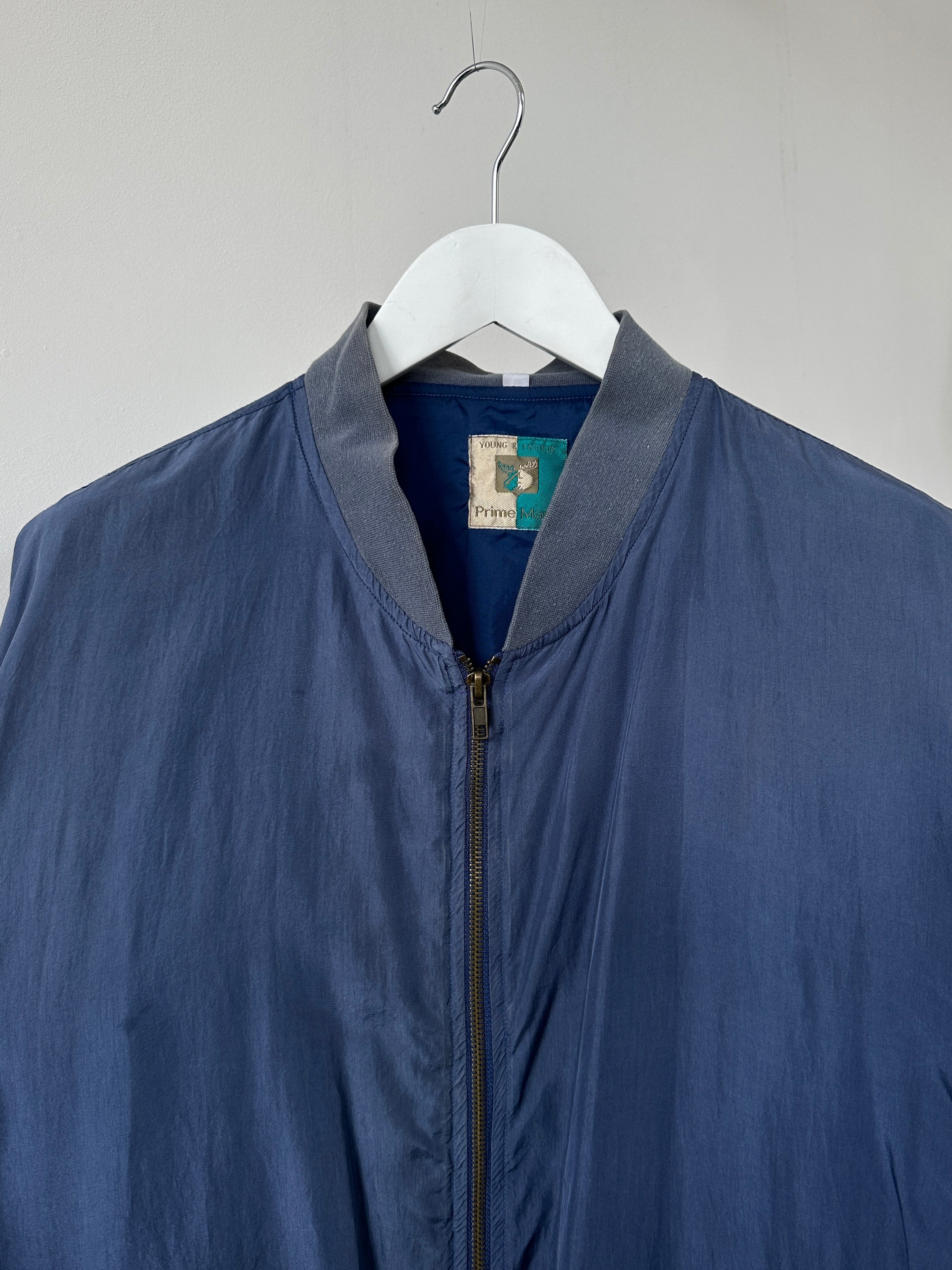 Vintage pure silk bomber jacket in XL size with a classic design, featuring a smooth silk fabric and stylish collar detail.