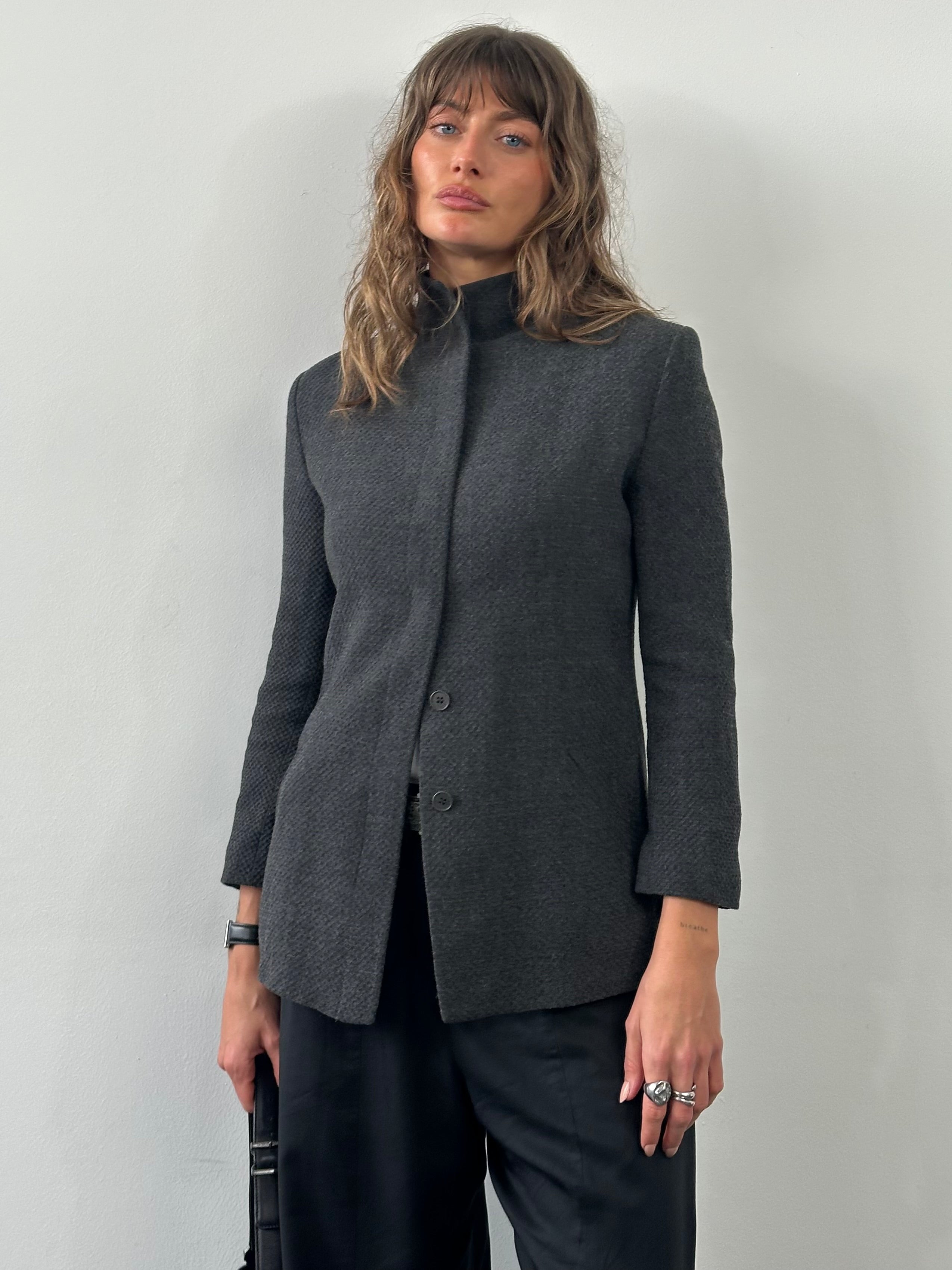 Emporio Armani 1990s high neck minimal jacket in XS/S, black with clean design and tailored fit, displayed on a hanger.