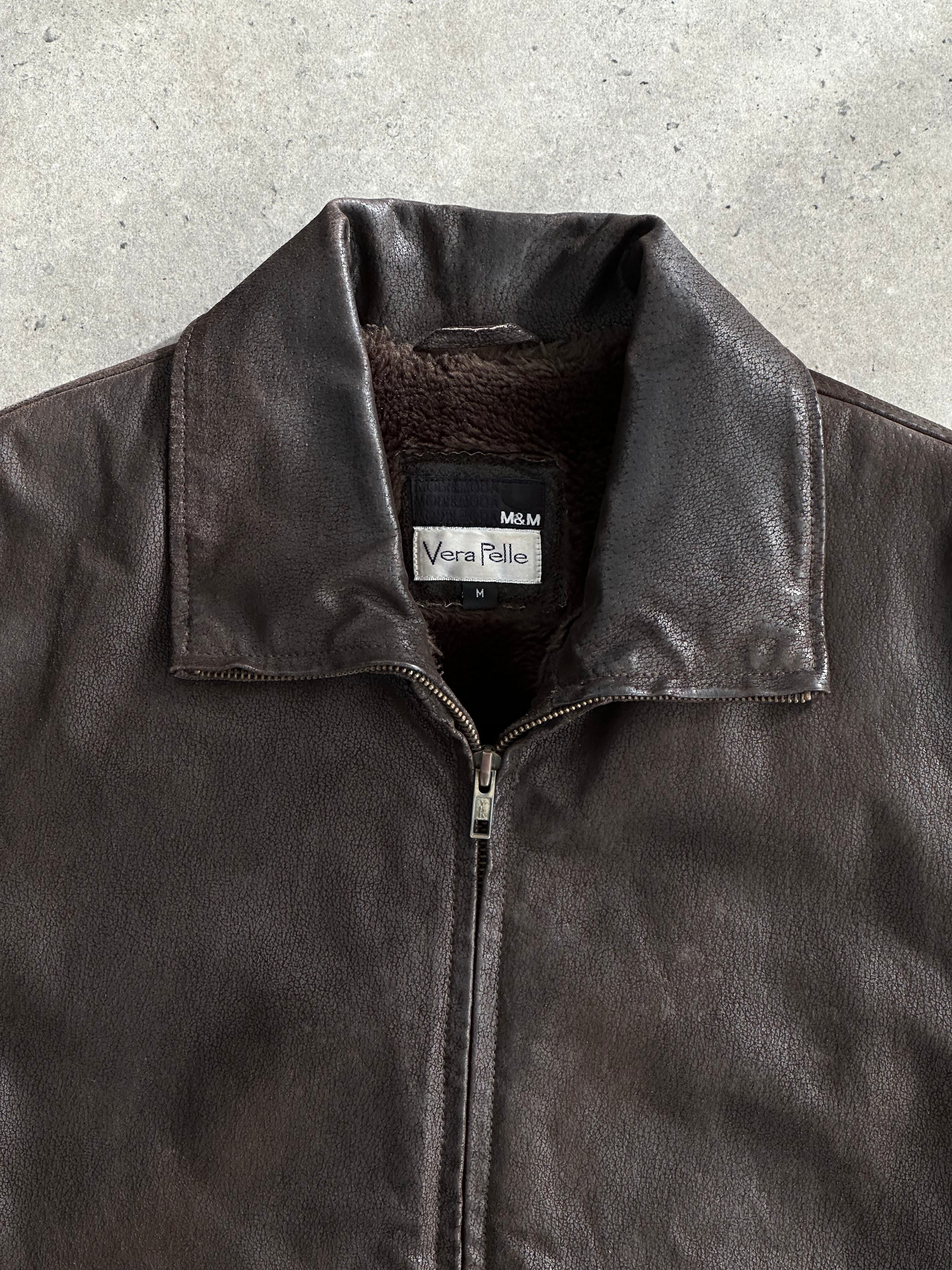 Vintage leather jacket with fur lining, featuring a classic design in size M/L, displayed on a hanger.