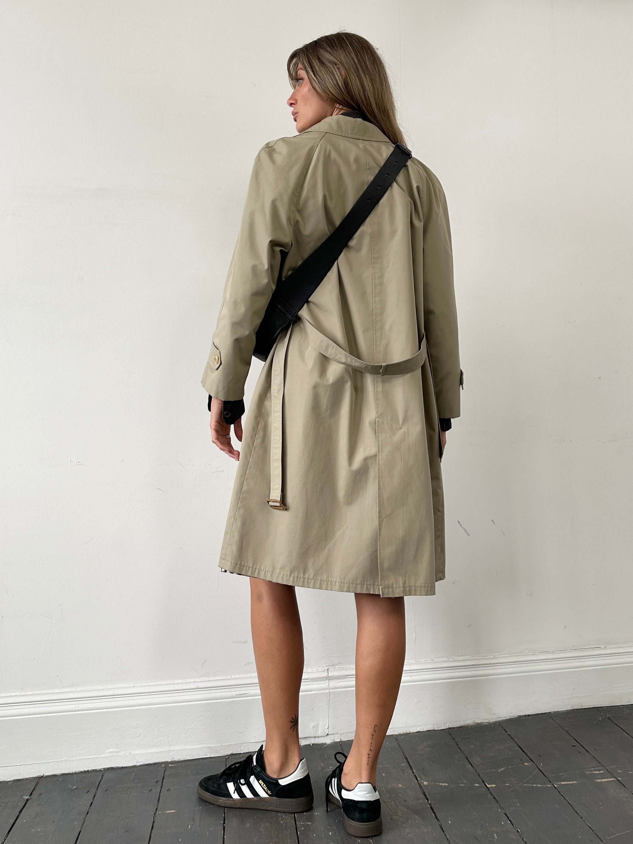 Vintage vintage showerproof belted trench coat, size M, showcasing classic design, waterproof fabric, and stylish belt detail.