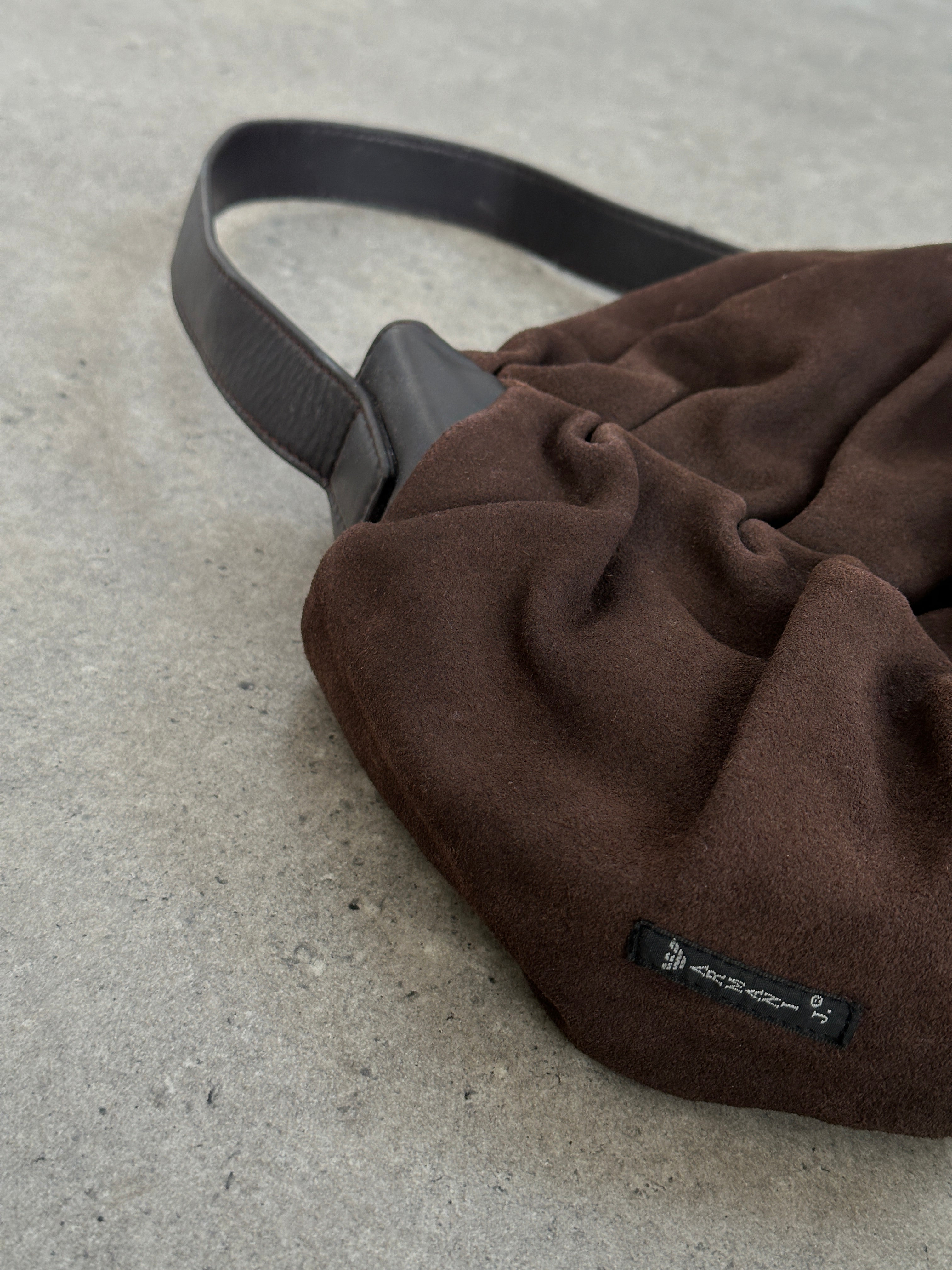 Armani Jeans suede shoulder bag with ruched detailing, featuring a stylish design and adjustable shoulder strap.