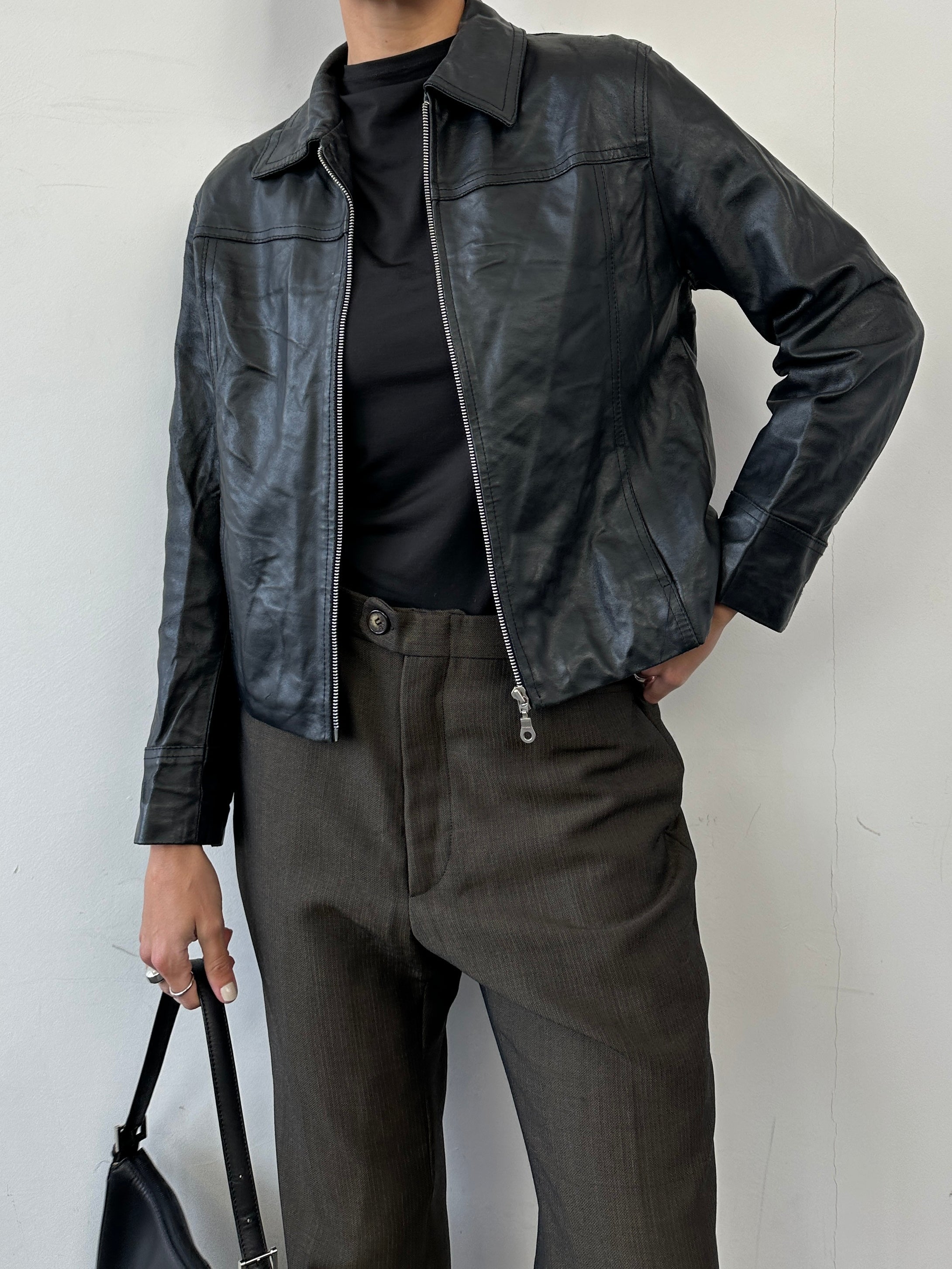 Vintage minimal zip-up leather jacket in size small, featuring a classic design with a sleek leather finish and subtle detailing.